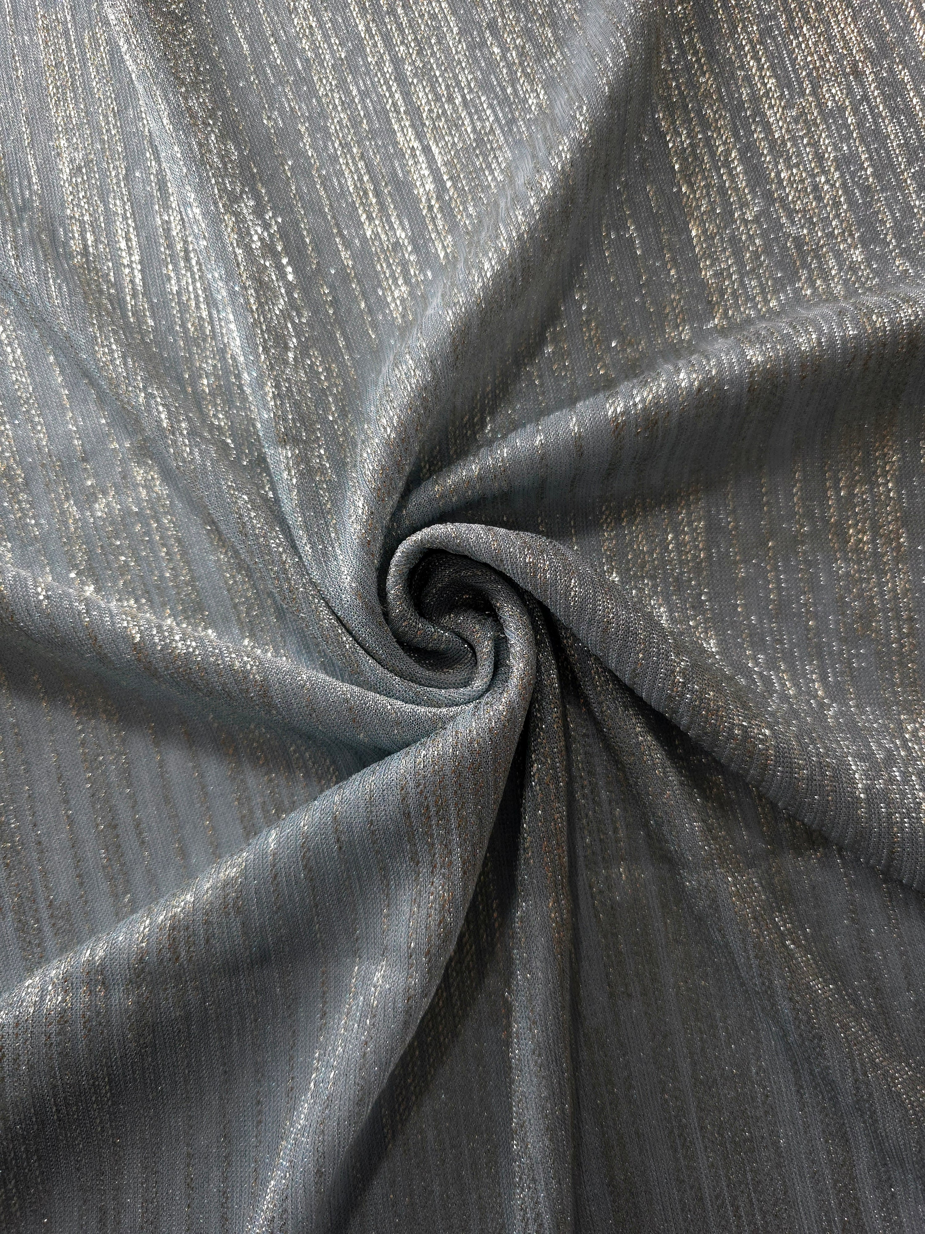 Swirl-draped Pewter Gray Sheer Metallic Shimmer Stretch Tulle Fabric showing fluid movement, reflective shimmer, airy transparency and flexible stretch for dresses, dancewear and stage looks