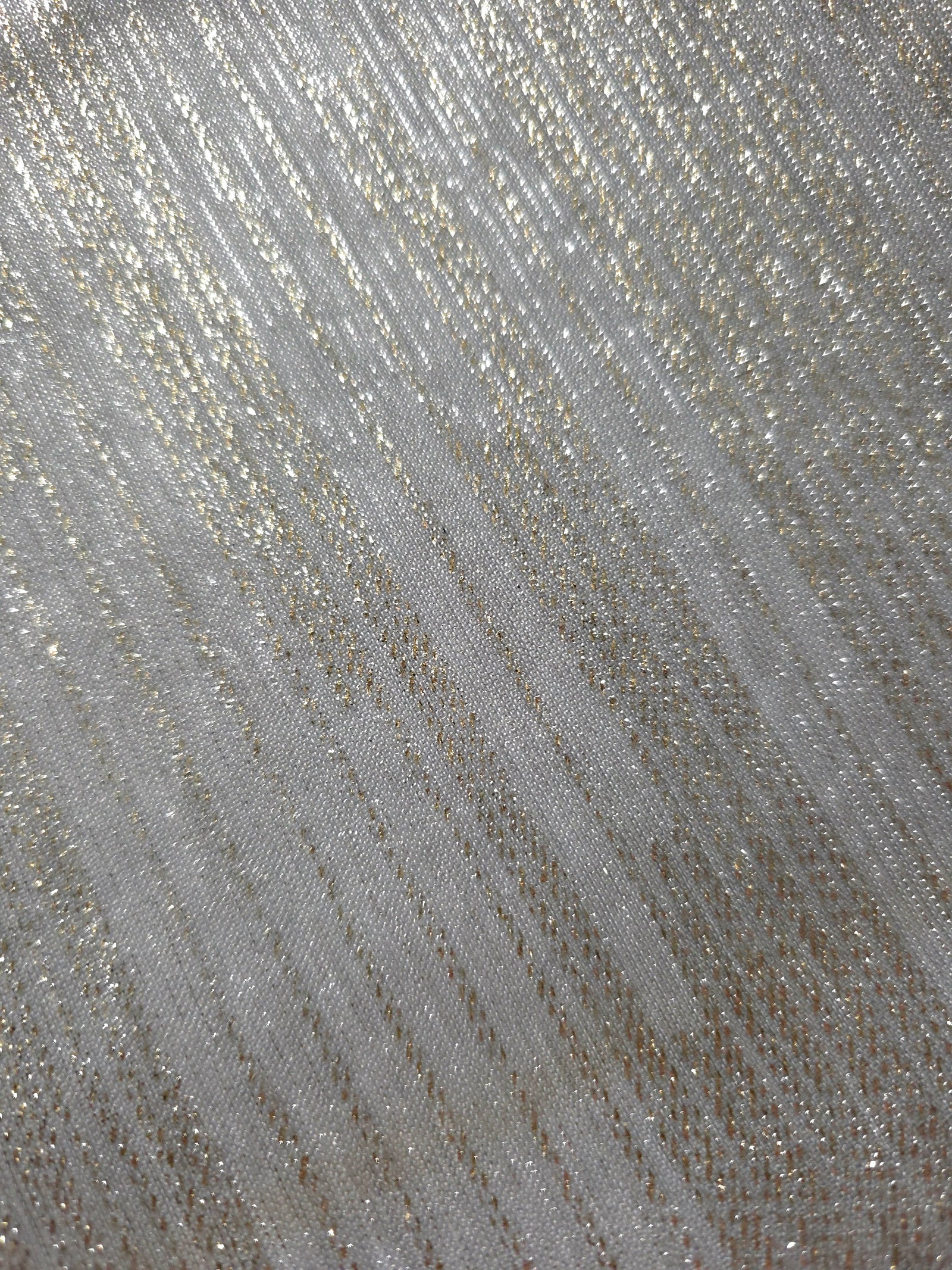 Close-up of Silver Gray Sheer Metallic Shimmer Stretch Tulle Fabric highlighting fine sheer mesh texture, metallic shimmer, lightweight stretch and subtle transparency for fashion and performance wear