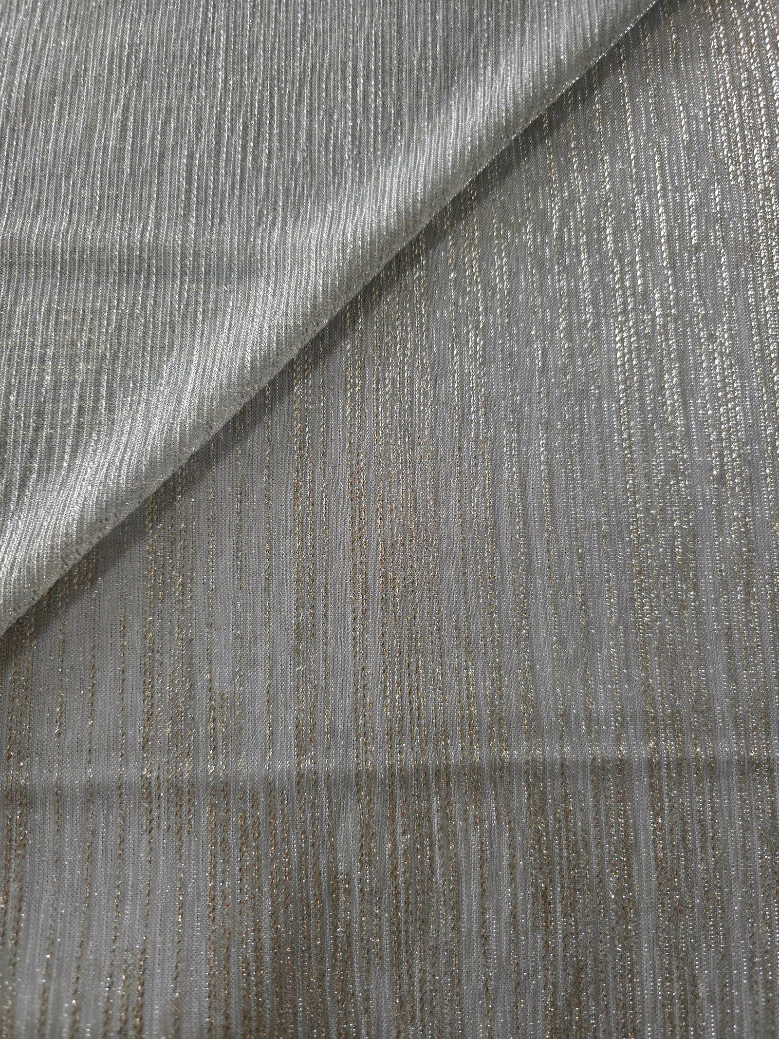 Silver Gray Sheer Metallic Shimmer Stretch Tulle Fabric shown front and back, revealing reflective metallic shimmer, translucent mesh structure and flexible stretch for layered garments, costumes and dancewear