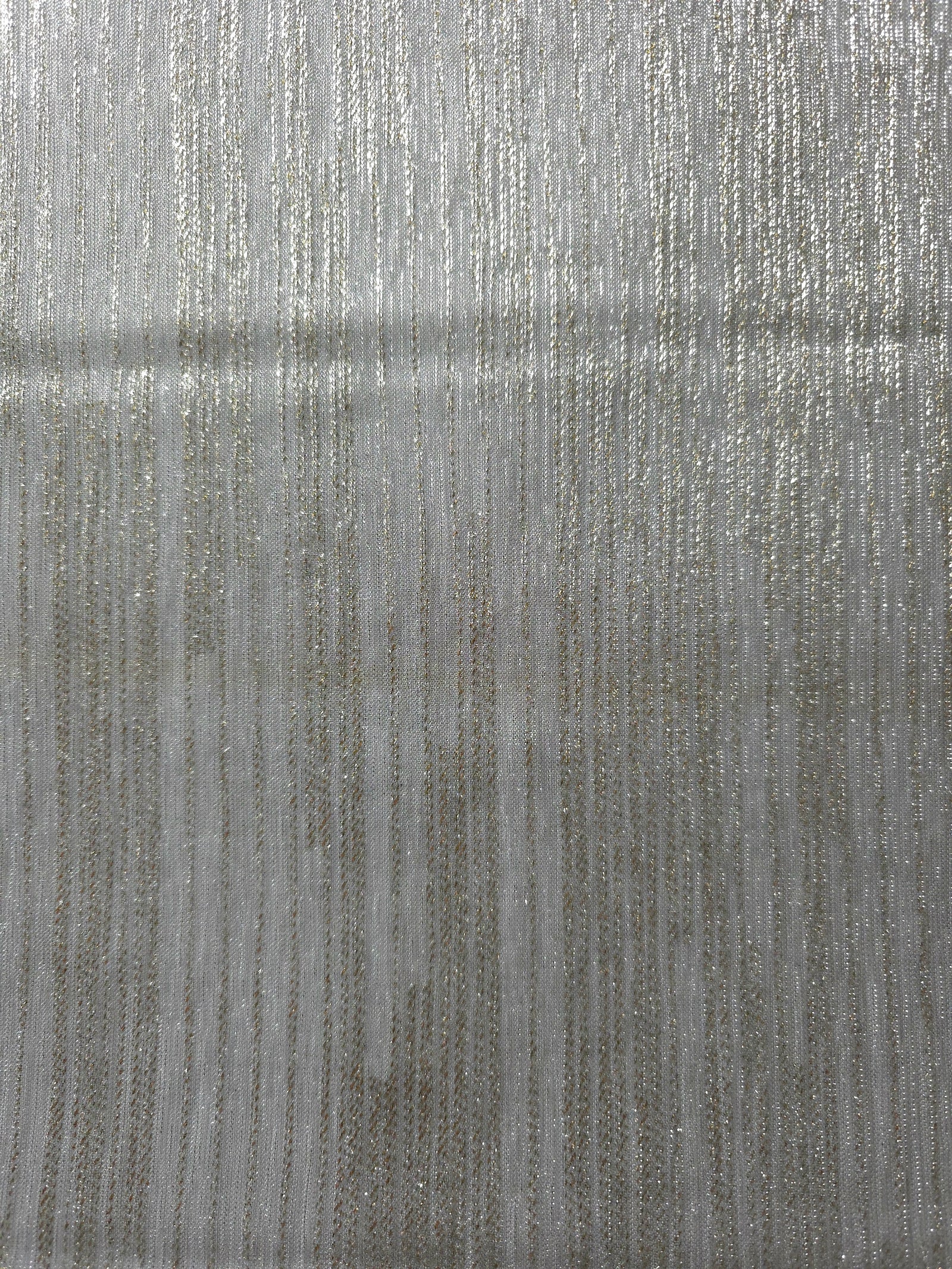 Surface view of Silver Gray Sheer Metallic Shimmer Stretch Tulle Fabric showing even metallic shimmer, fine sheer tulle texture, translucent finish and stretch for overlays, dresses and performance wear