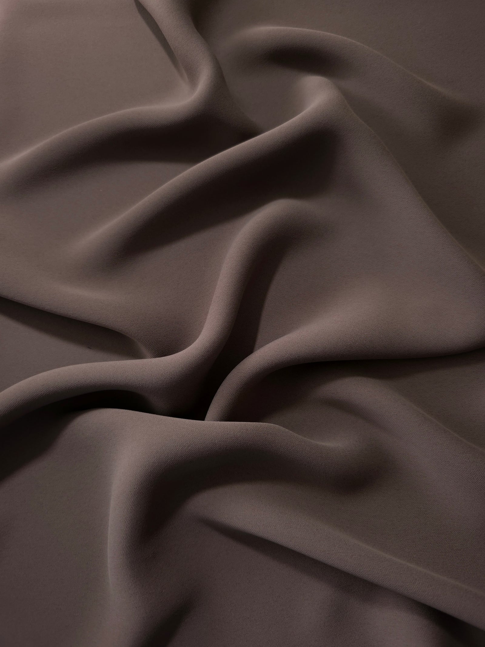Long draped folds of Dark Cocoa Taupe Korean crepe showing opaque coverage for abayas, dresses and modest wear