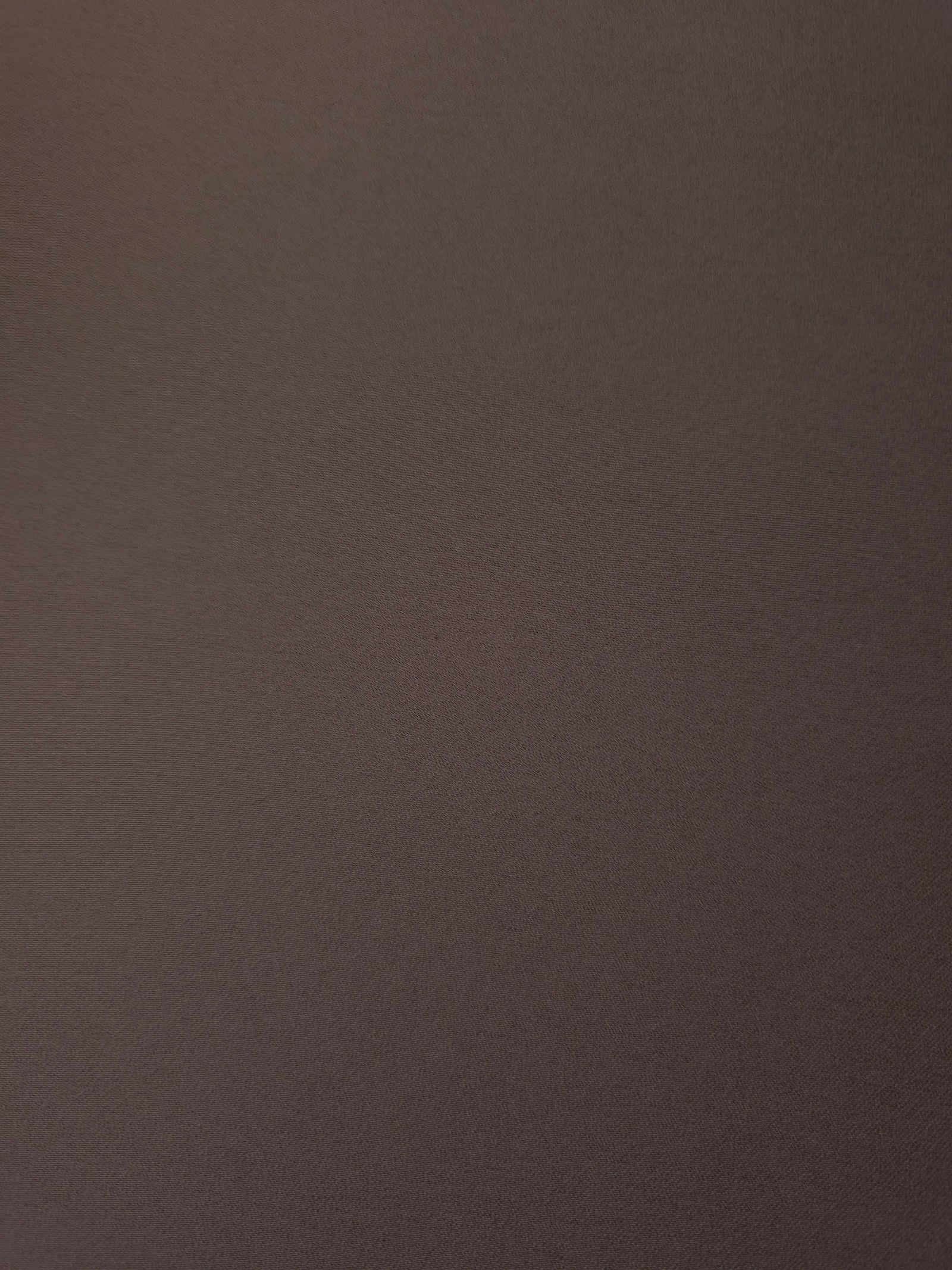 Fine texture close-up of Dark Cocoa Taupe 100% mechanical polyester crepe showing a smooth, silky-soft woven hand