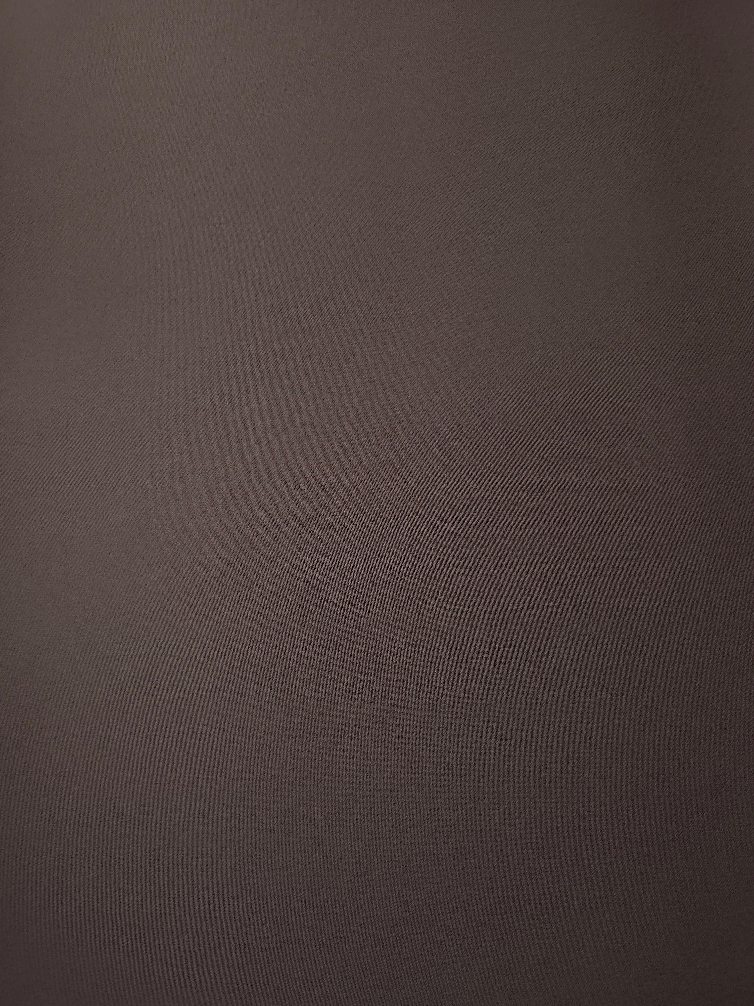 Flat surface of Dark Cocoa Taupe Korean crepe, a 205 GSM opaque polyester fabric with smooth dressmaking character