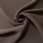 Circular drape of Dark Cocoa Taupe polyester crepe showing flowing movement for occasion dresses and modest fashion