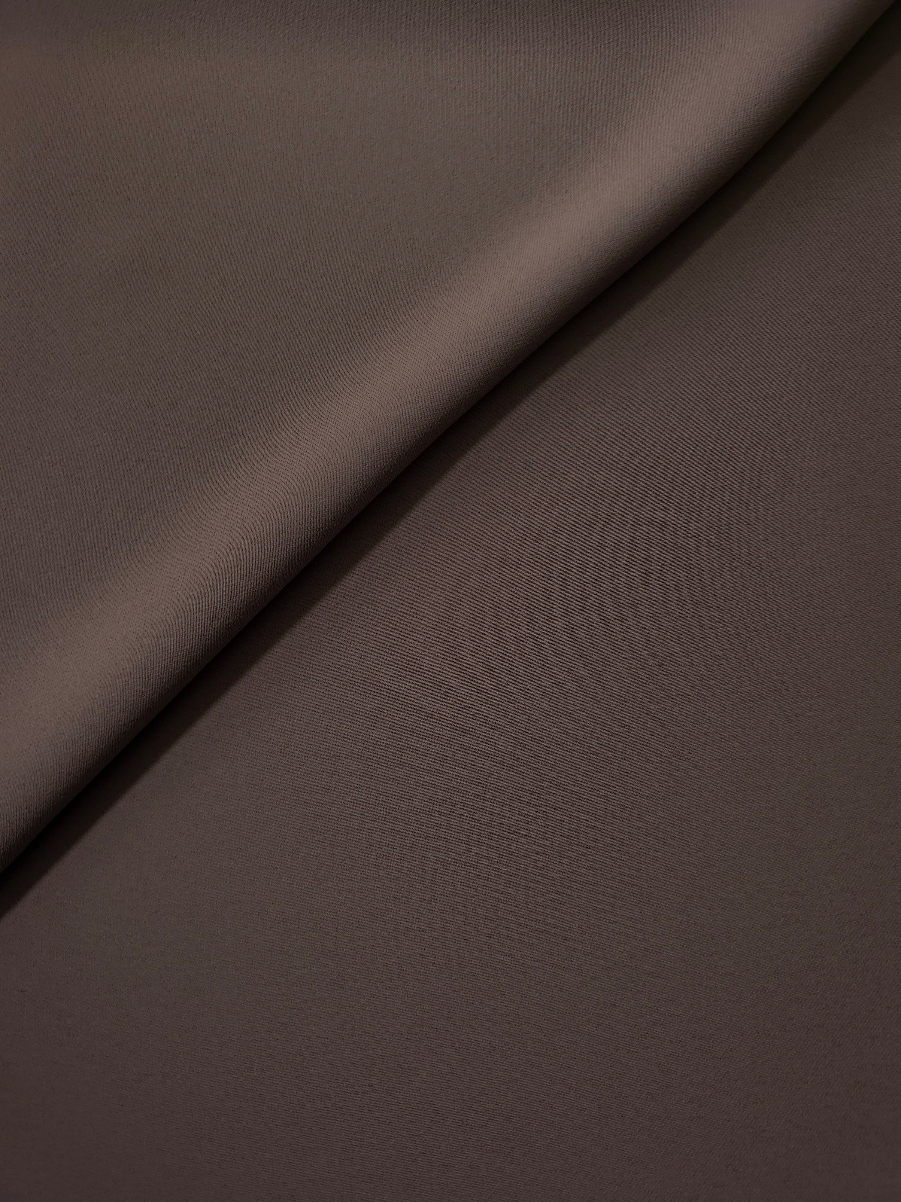 Soft-fold view of Dark Cocoa Taupe Korean polyester crepe showing fluid drape for blouses, skirts and dresses