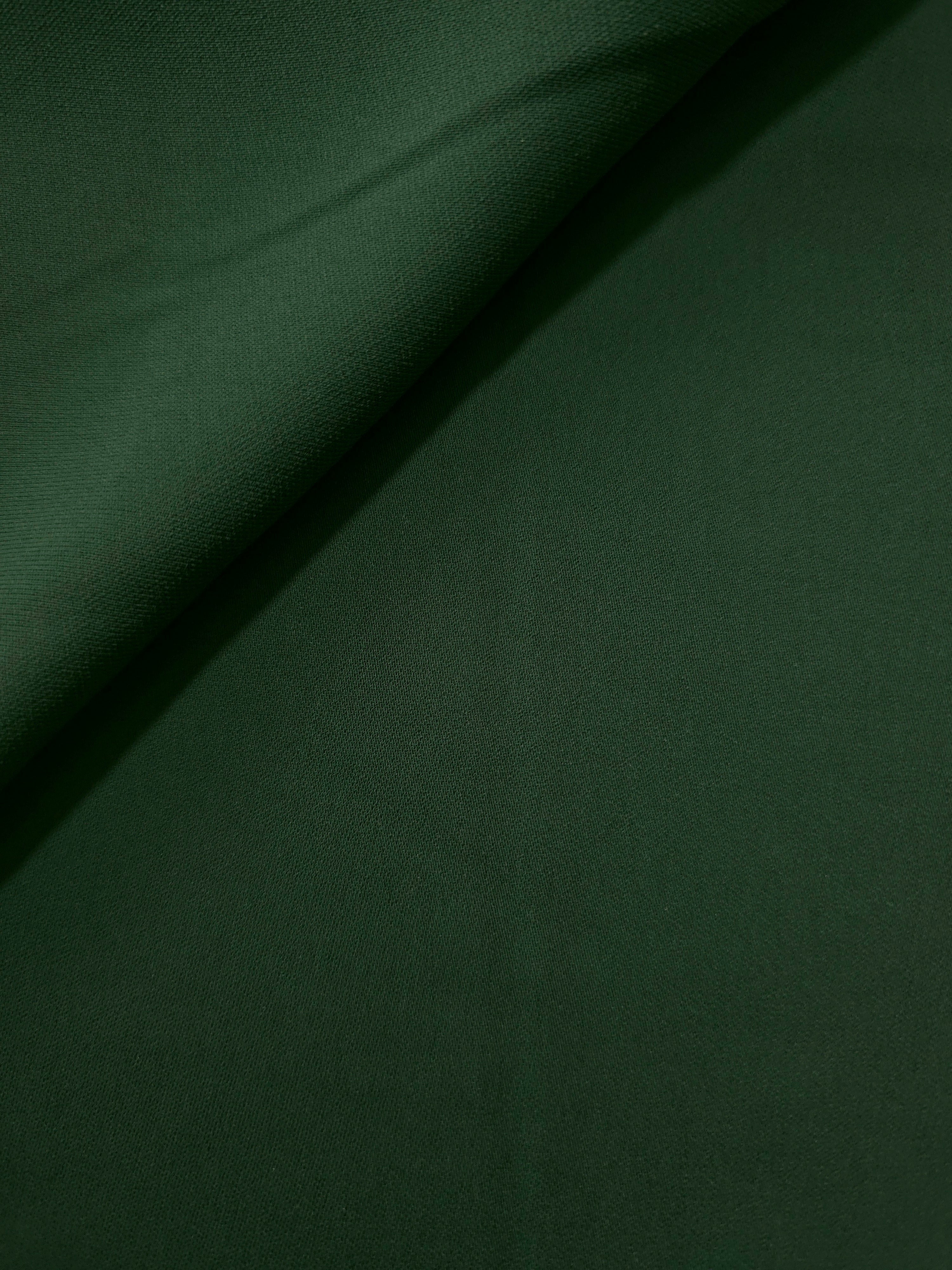 Dark Hunter Green silky-feel crepe folded loosely to show fluid drape for blouses and elegant separates