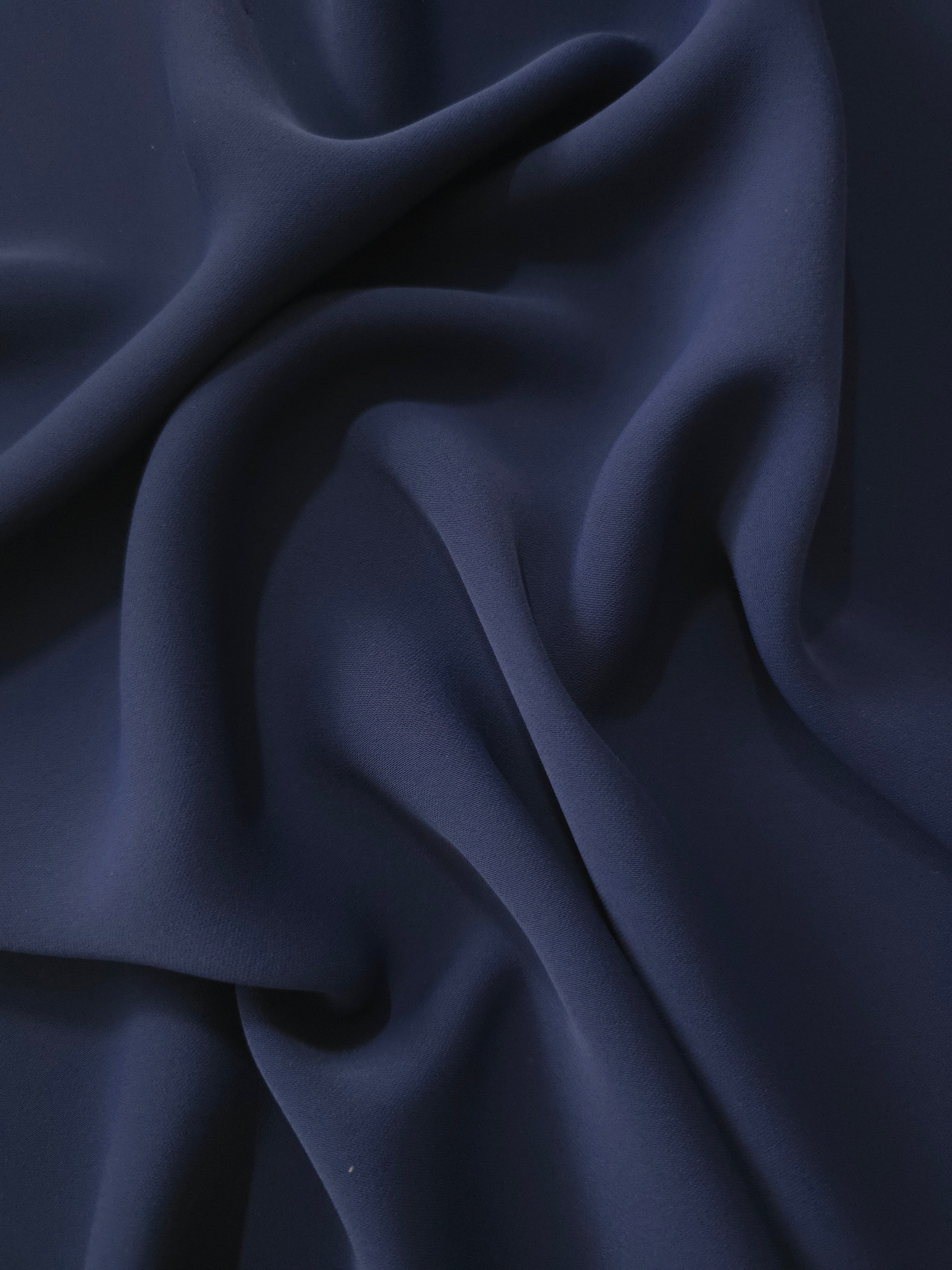 Dark Navy Blue polyester crepe cascading in soft folds for occasion dresses, modest wear and flowing apparel