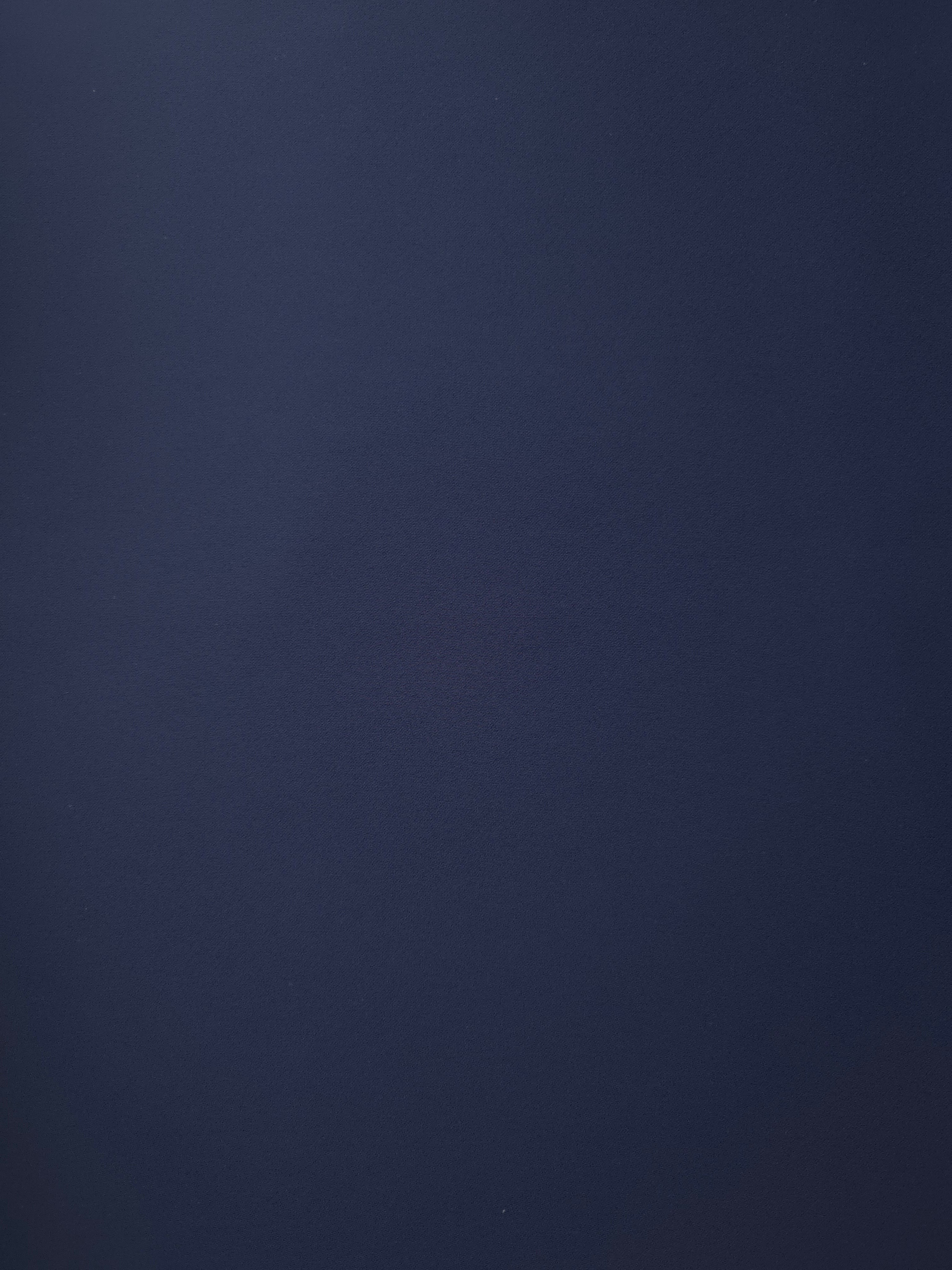 Flat lay of Dark Navy Blue polyester crepe, smooth Italian-style apparel fabric with a soft refined finish
