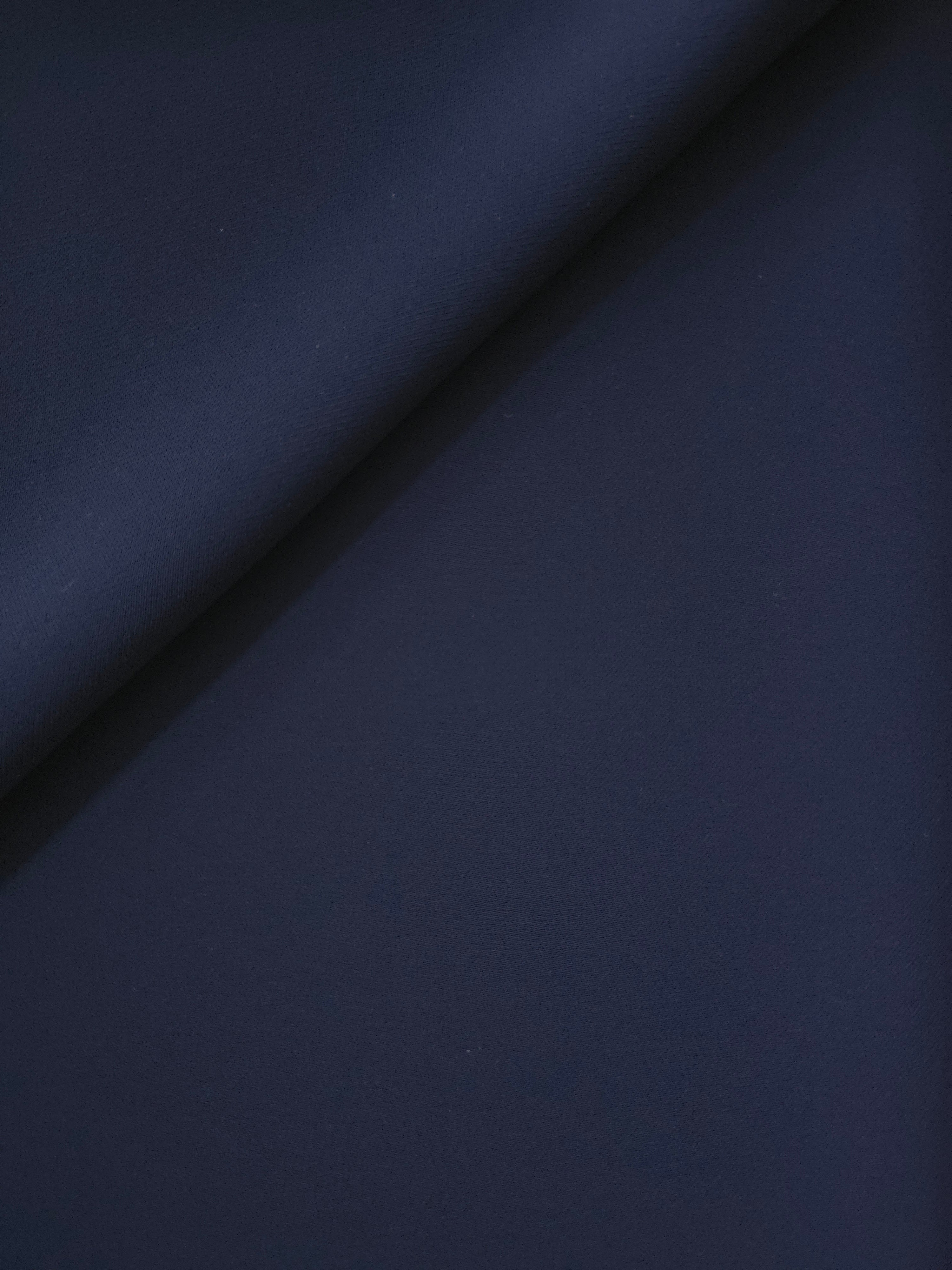 Relaxed fold of Dark Navy Blue polyester crepe showing fluid movement for blouses, dresses and skirts