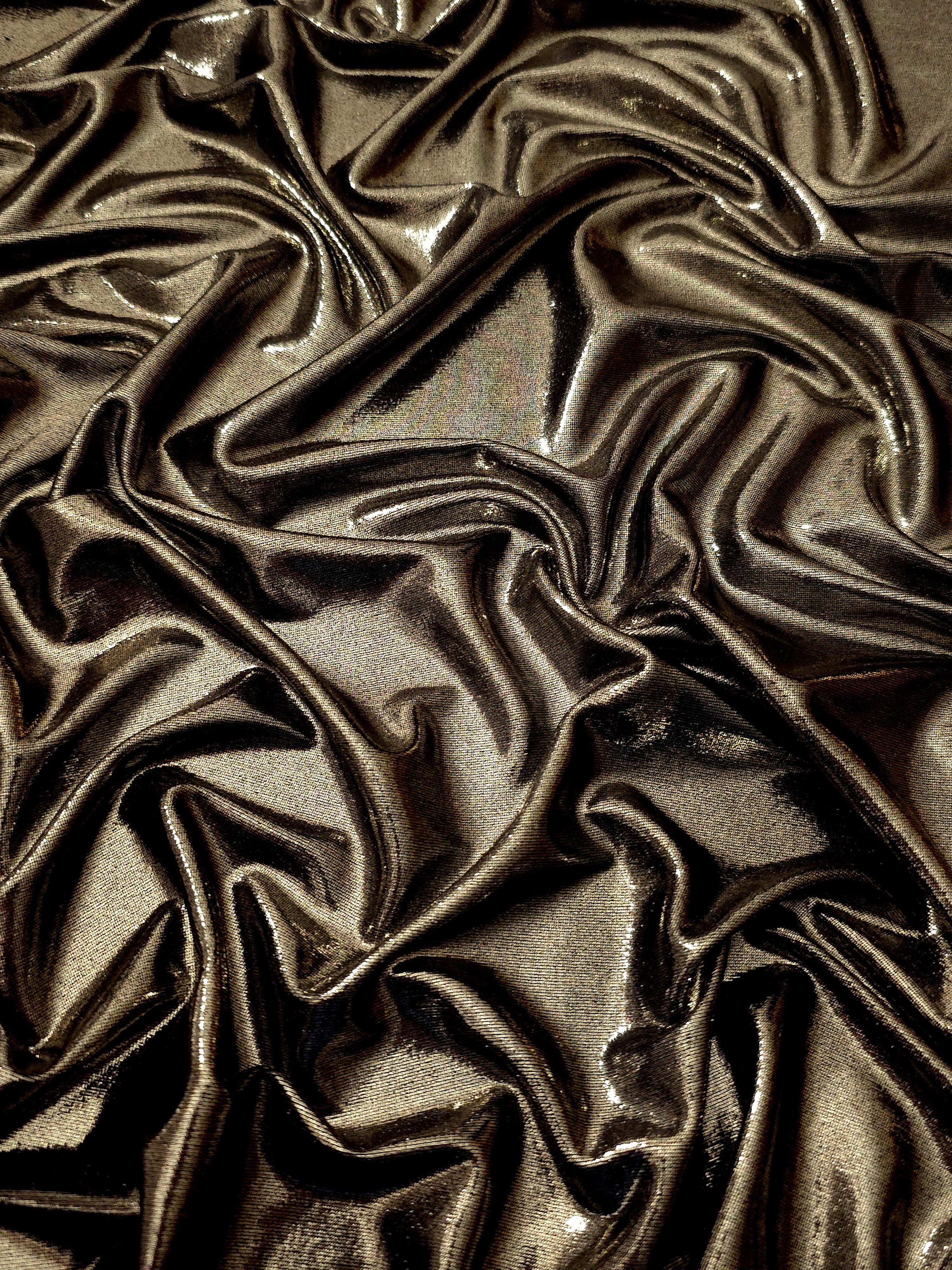 Dark Olive Taupe metallic stretch fabric arranged in elegant folds, showing reflective movement for occasionwear, costumes and fashion design