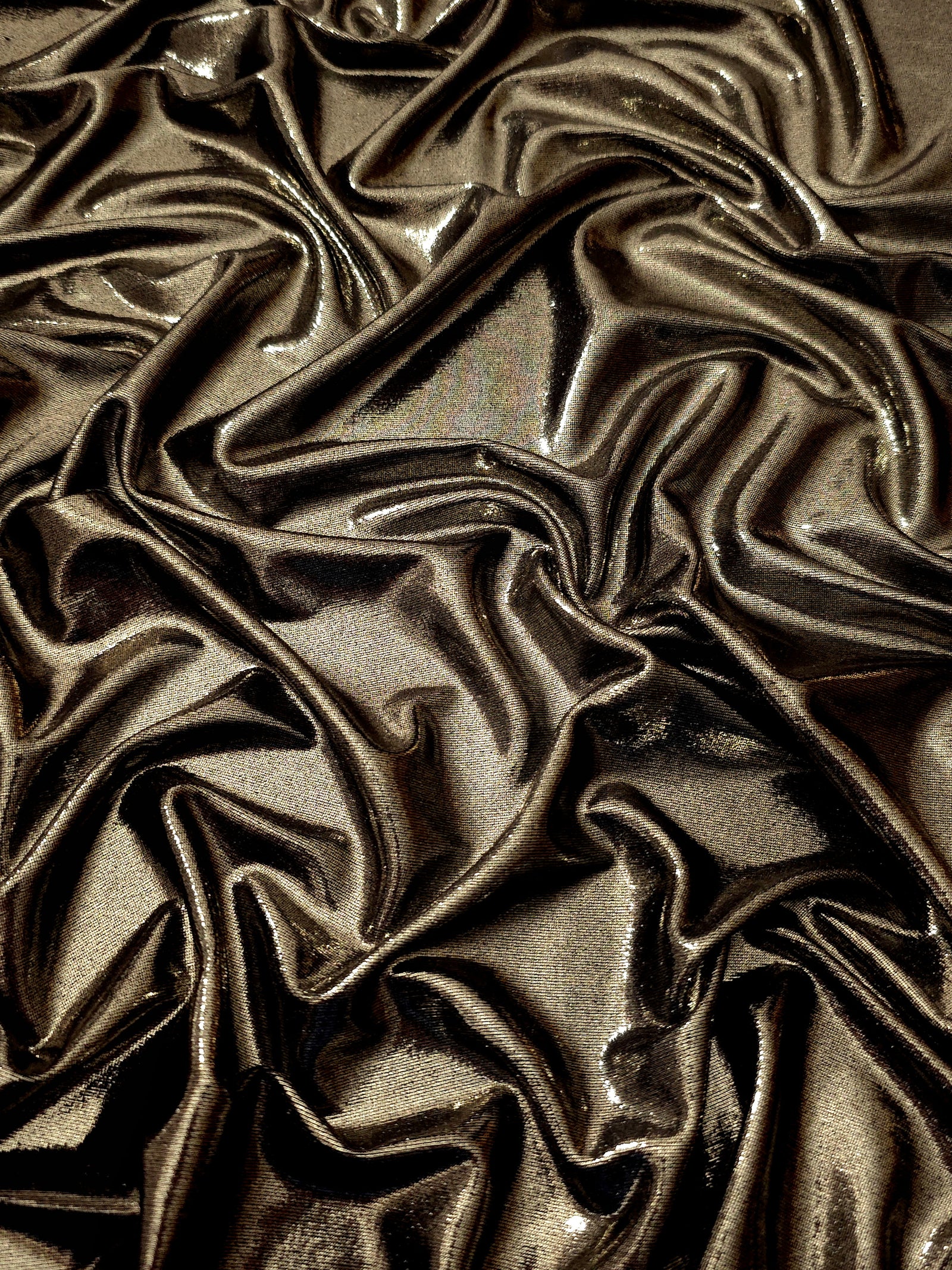 Dark Olive Taupe metallic stretch fabric arranged in elegant folds, showing reflective movement for occasionwear, costumes and fashion design