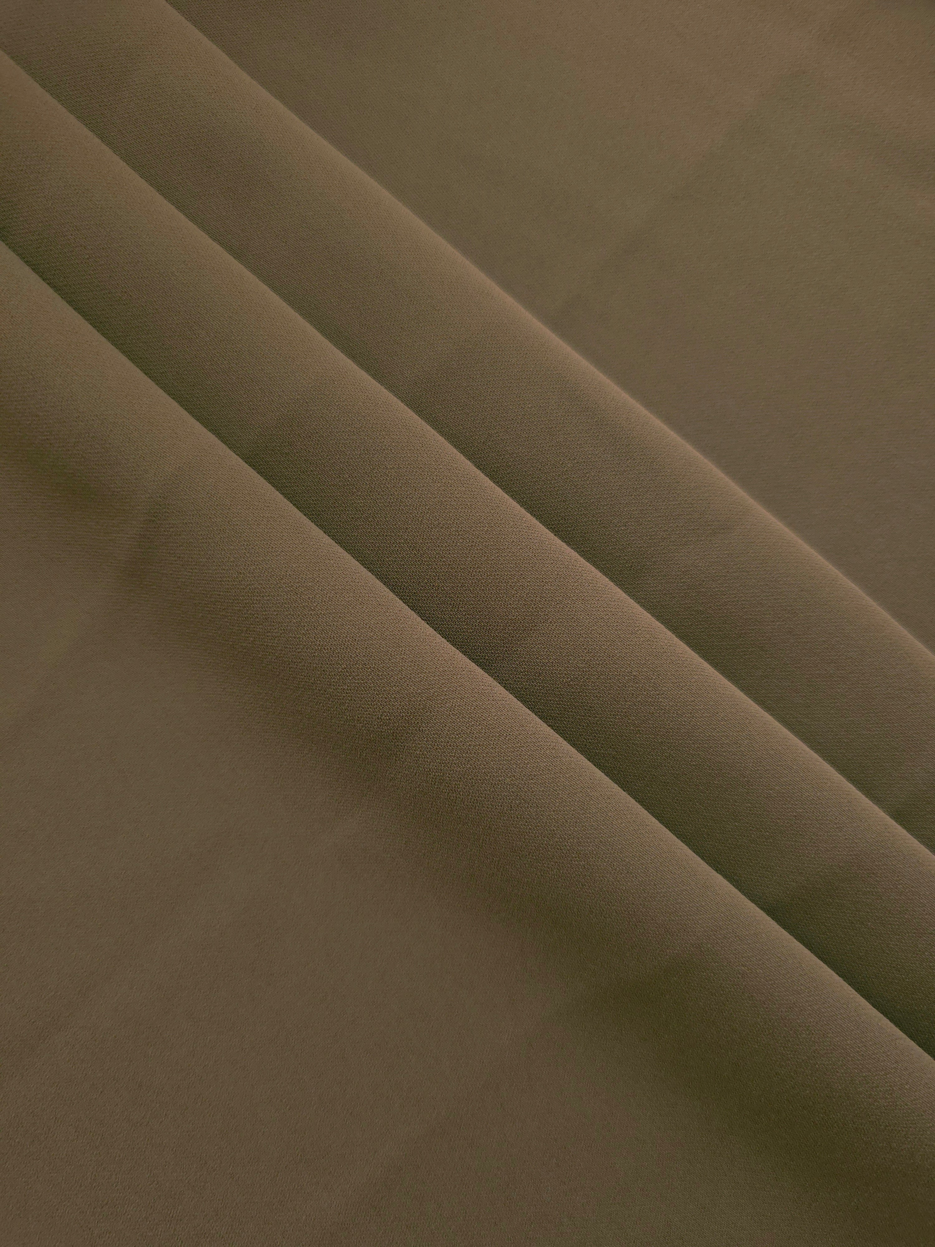 Layered Dark Olive Taupe mechanical polyester crepe showing soft structure and gentle stretch for tailoring