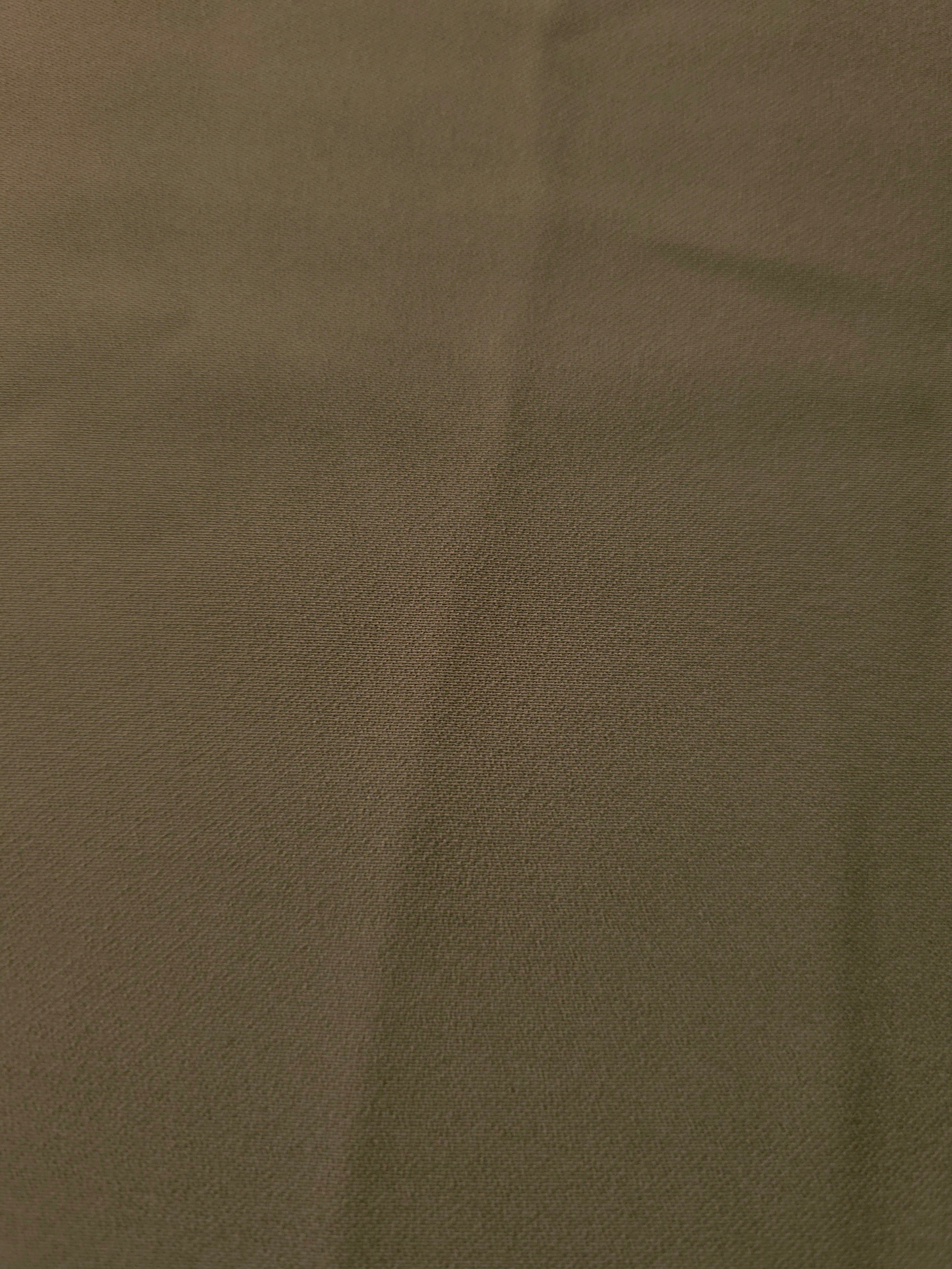 Close-up of Dark Olive Taupe mechanical polyester crepe showing fine texture and a smooth silky-soft hand