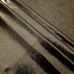 Layered Dark Olive Taupe metallic stretch fabric with reflective foil finish, showing flexible body for dancewear and occasion fashion