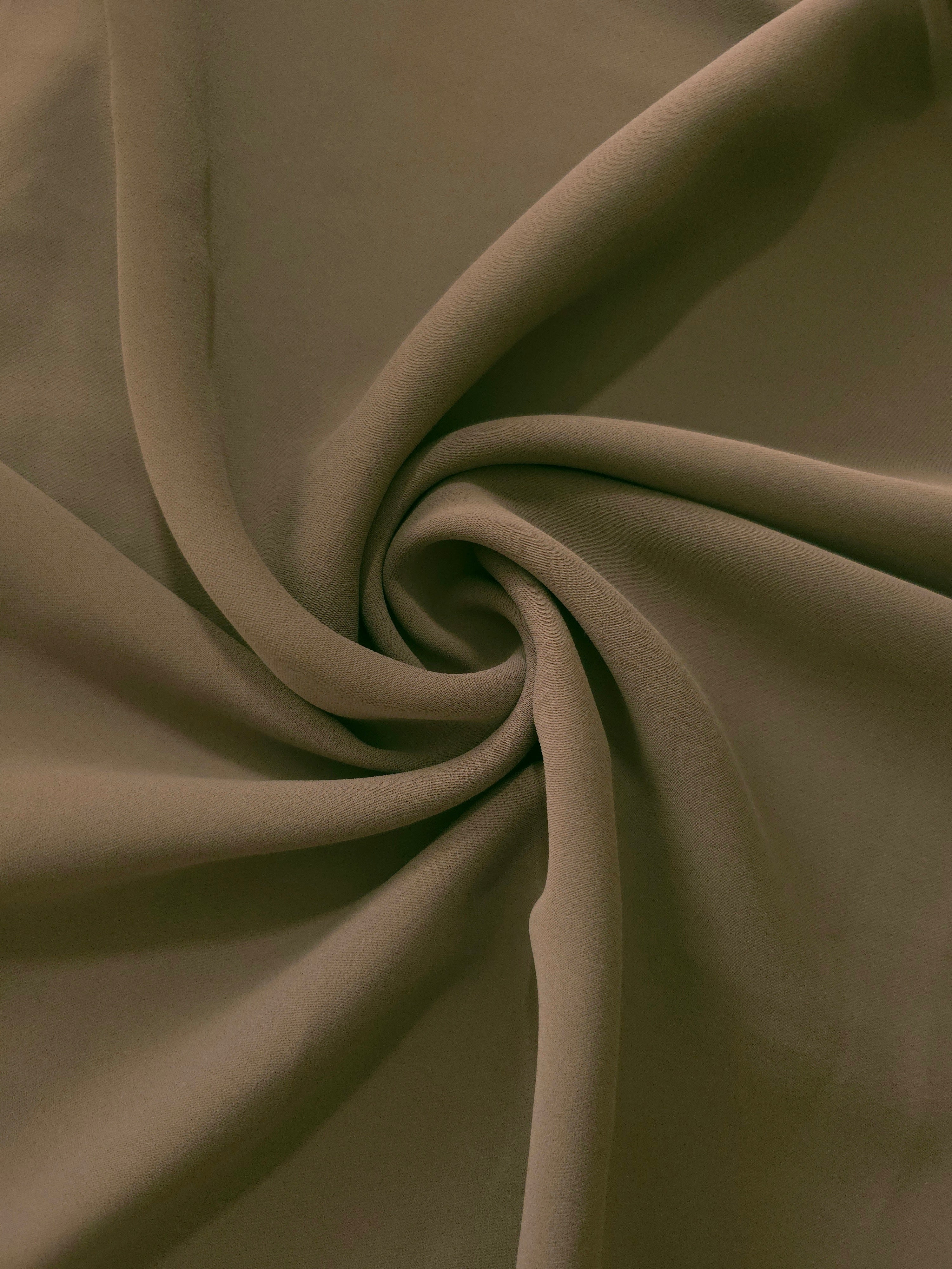 Dark Olive Taupe silky-feel polyester crepe styled in a swirl to show flowing drape for modest fashion