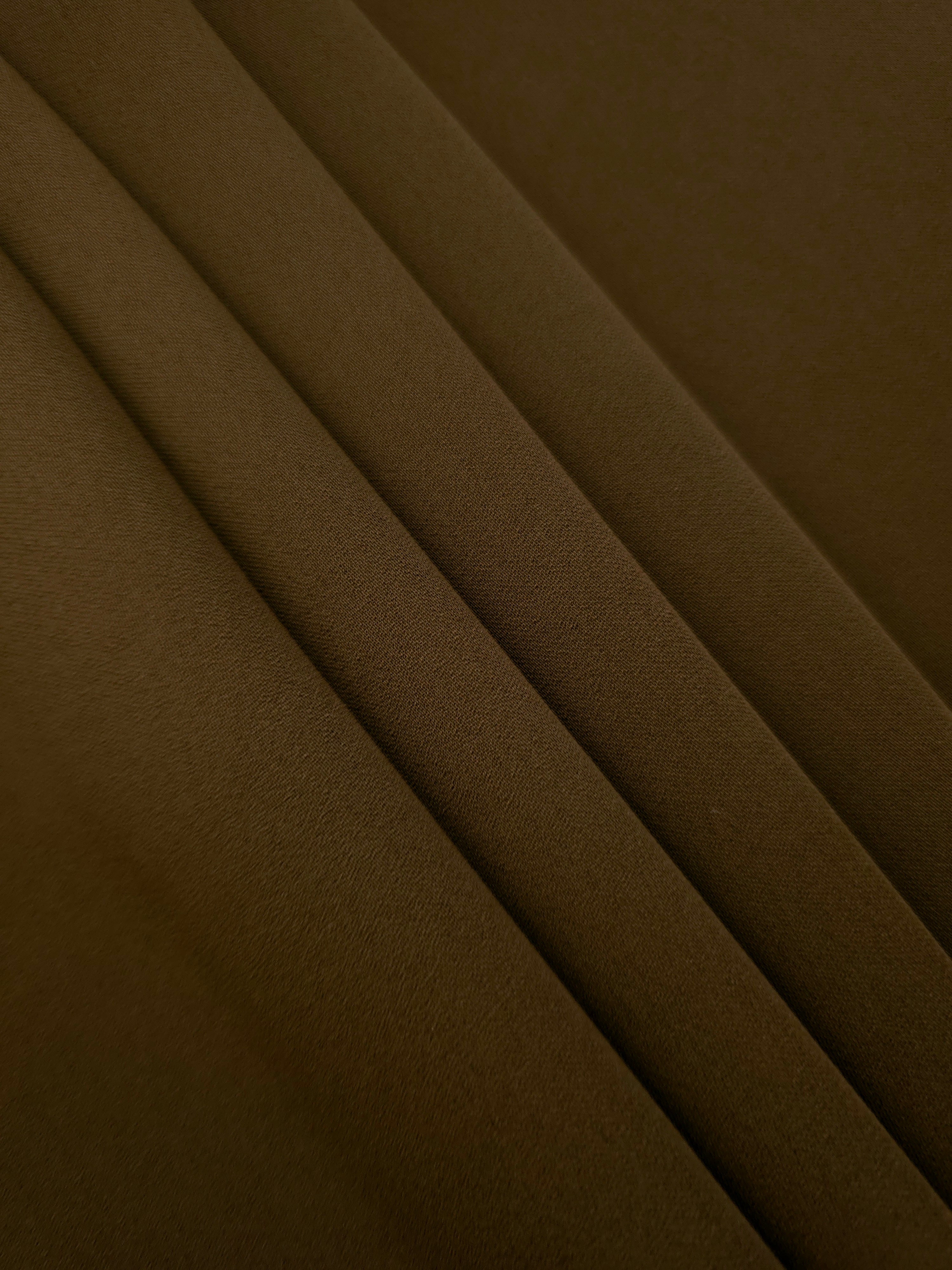 Dark Walnut Brown Korean crepe in layered folds, showing soft structure and slight mechanical stretch for skirts