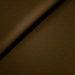 Soft fold of Dark Walnut Brown opaque polyester crepe showing fluid dressmaking drape for dresses and skirts