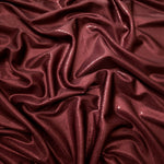 Draped Deep Burgundy shimmer spandex fabric with luminous foil reflection, suited to gowns, skirts and theatrical apparel