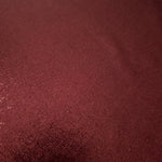 Texture view of Deep Burgundy metallic stretch fabric, highlighting foil shimmer and surface detail for performance apparel