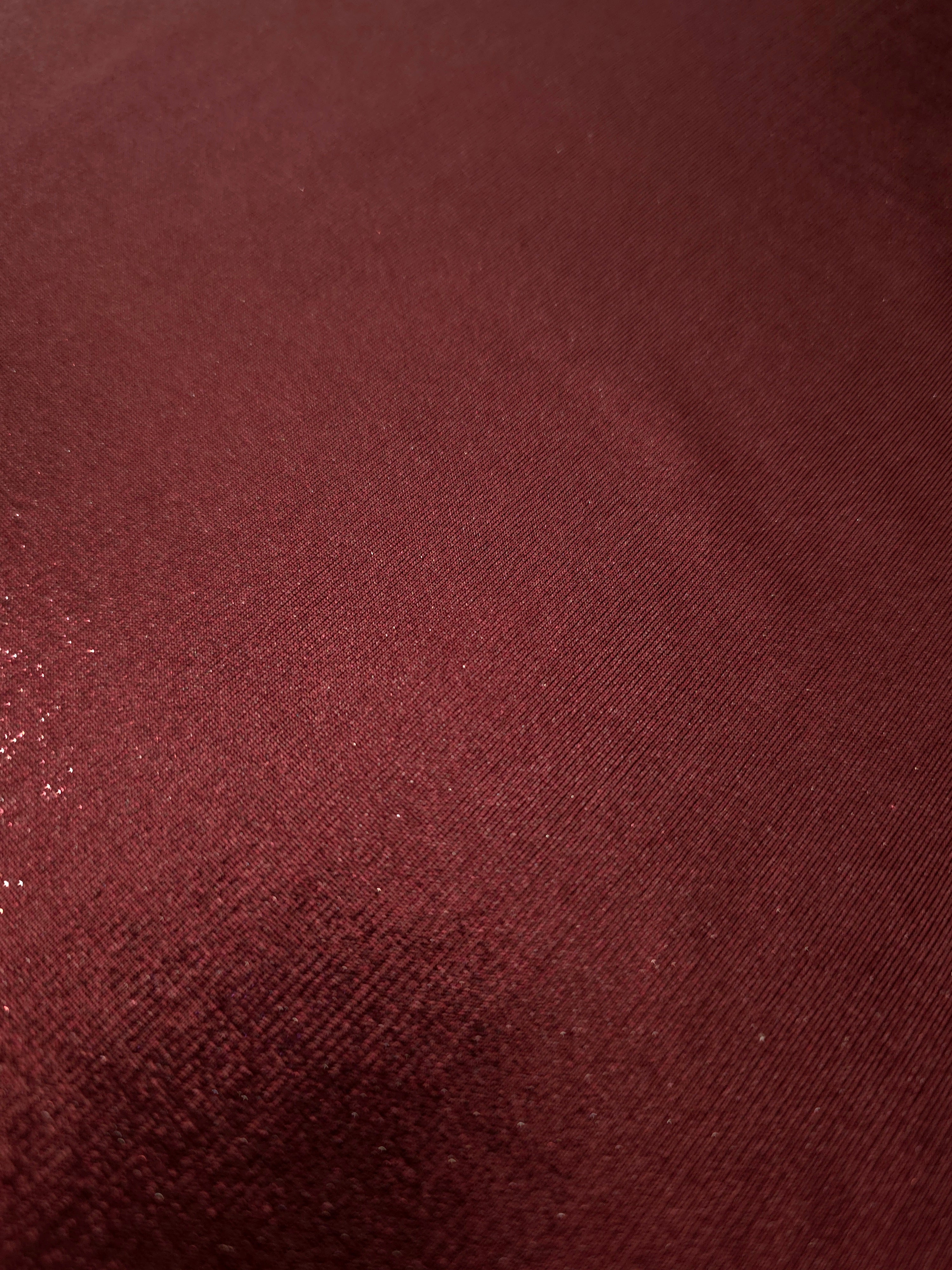 Texture view of Deep Burgundy metallic stretch fabric, highlighting foil shimmer and surface detail for performance apparel