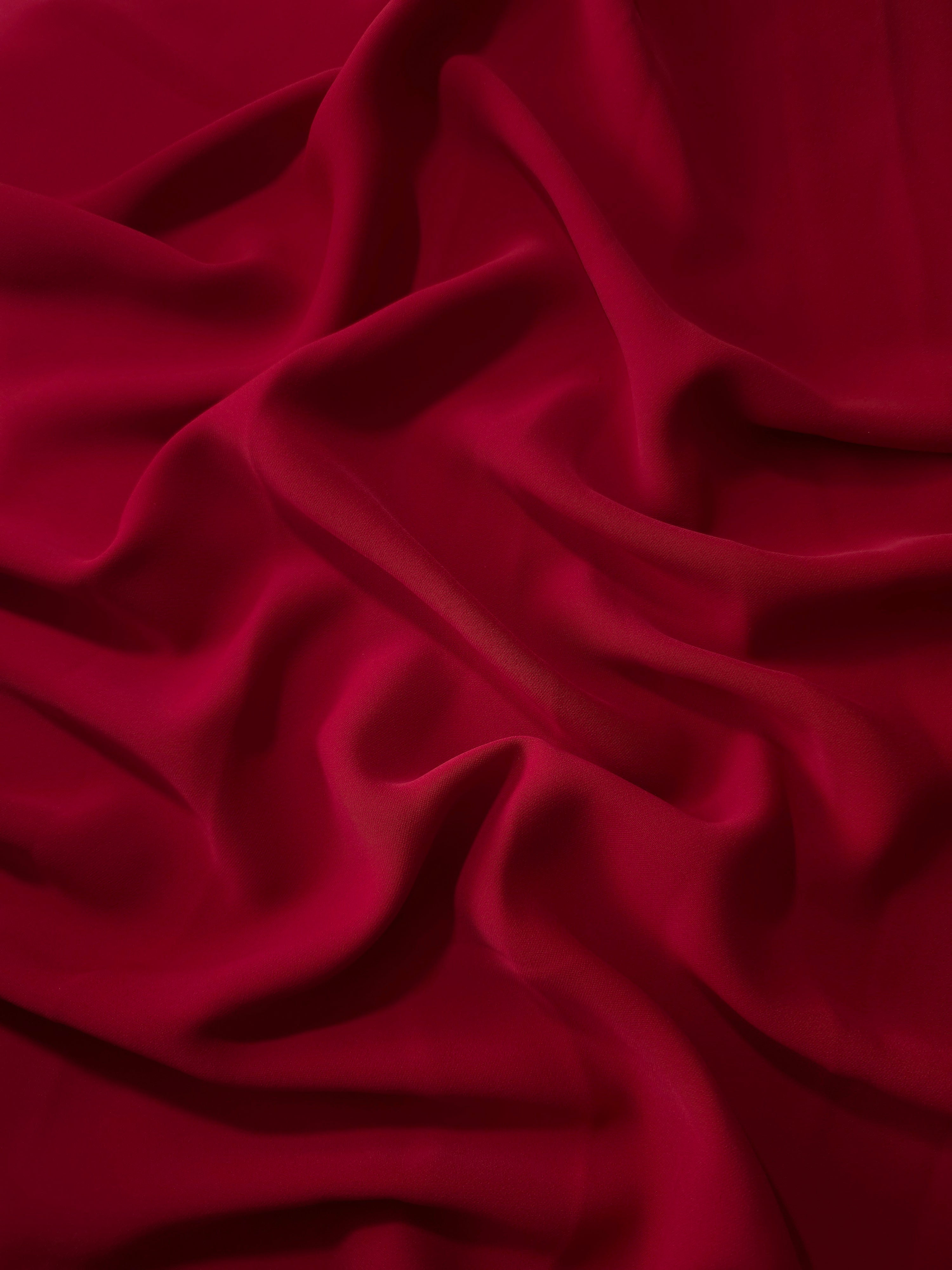 Deep Cherry Red polyester crepe in long draped folds, showing flowing coverage for abayas and modest fashion