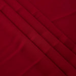Deep Cherry Red Korean crepe in layered folds, showing soft structure and slight mechanical stretch for skirts