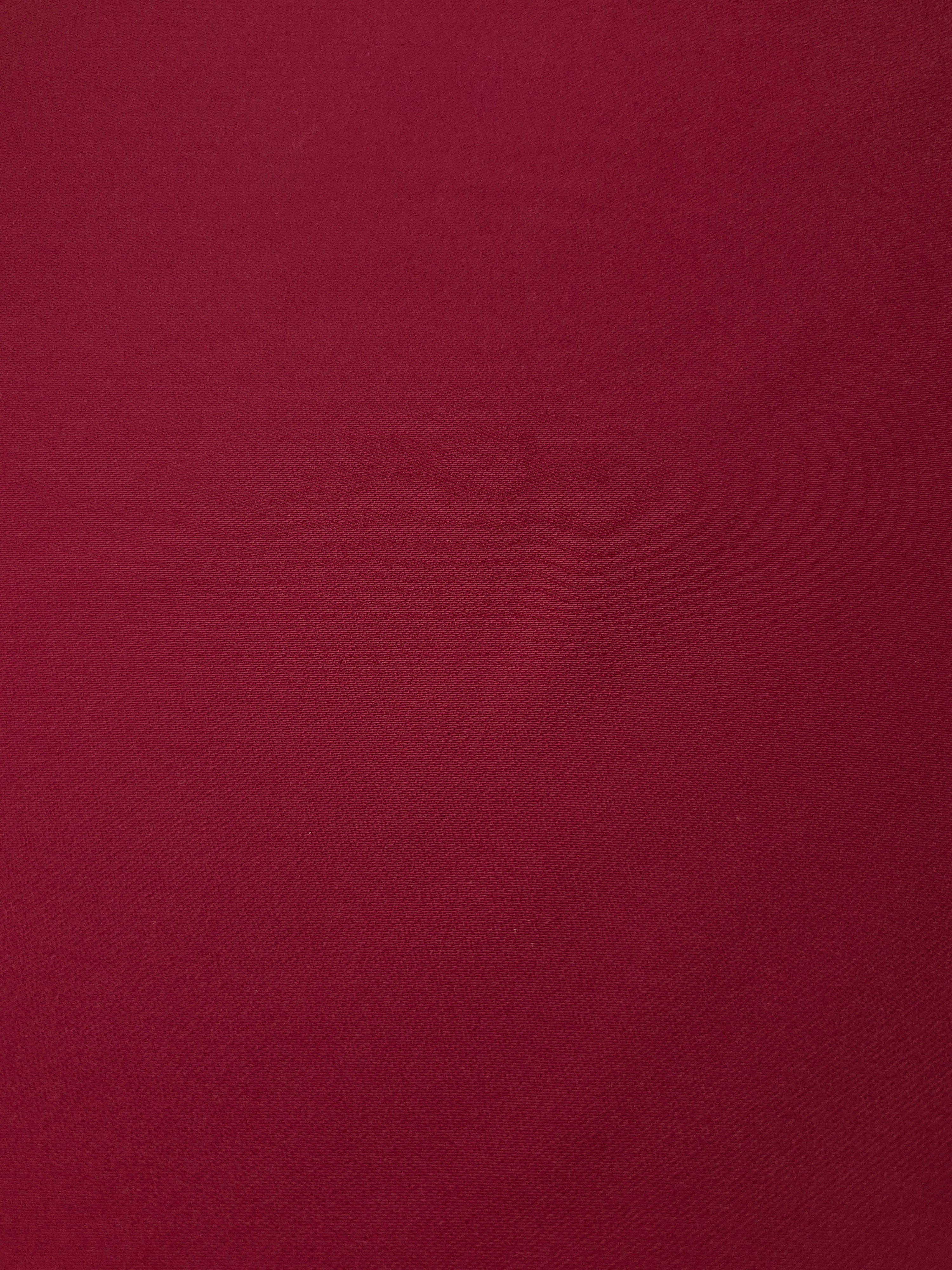 Fine texture close-up of Deep Cranberry Red mechanical polyester crepe showing a smooth silky-soft woven hand