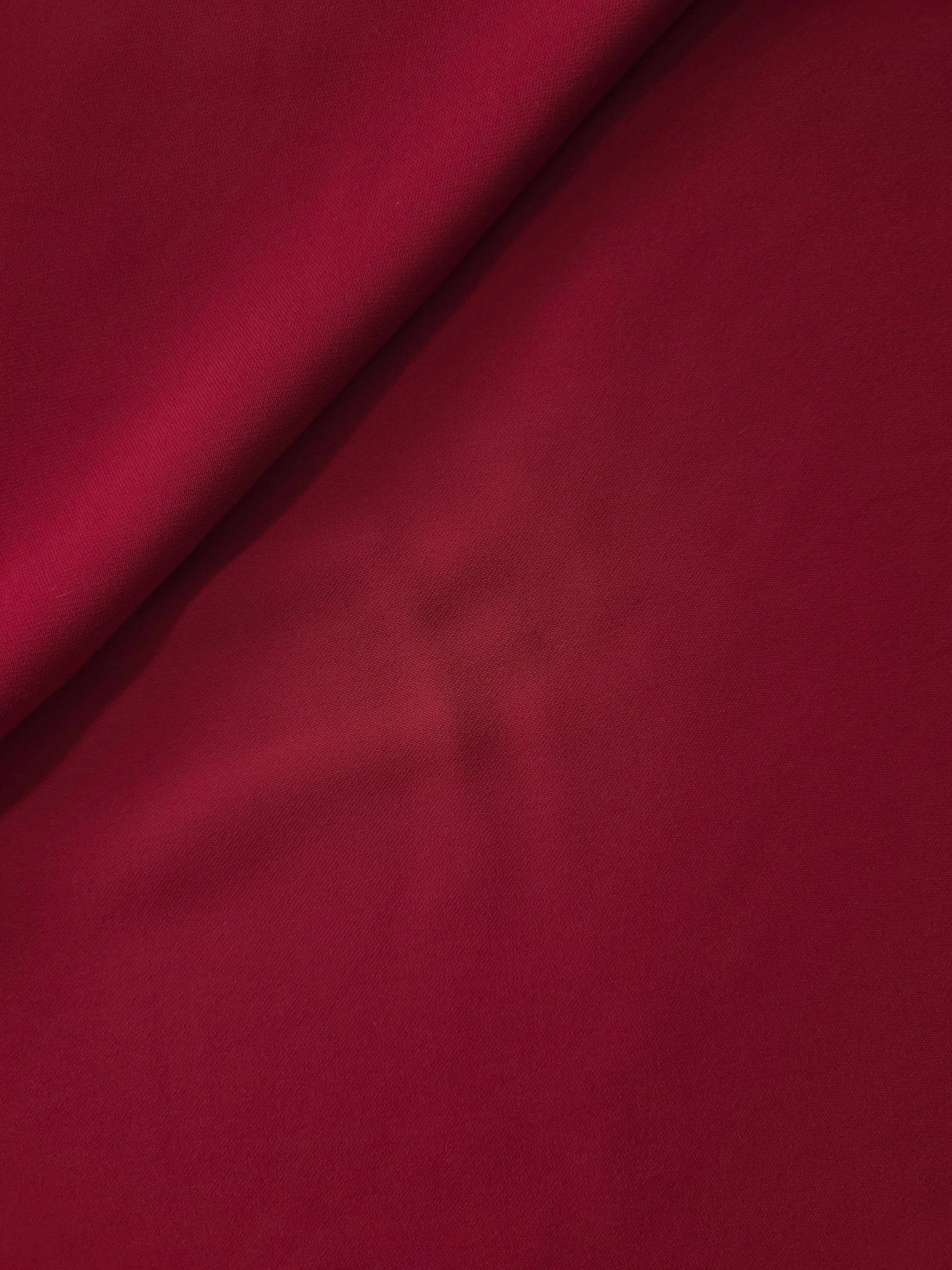 Soft-fold view of Deep Cranberry Red polyester crepe showing fluid drape for dresses, skirts and blouse making