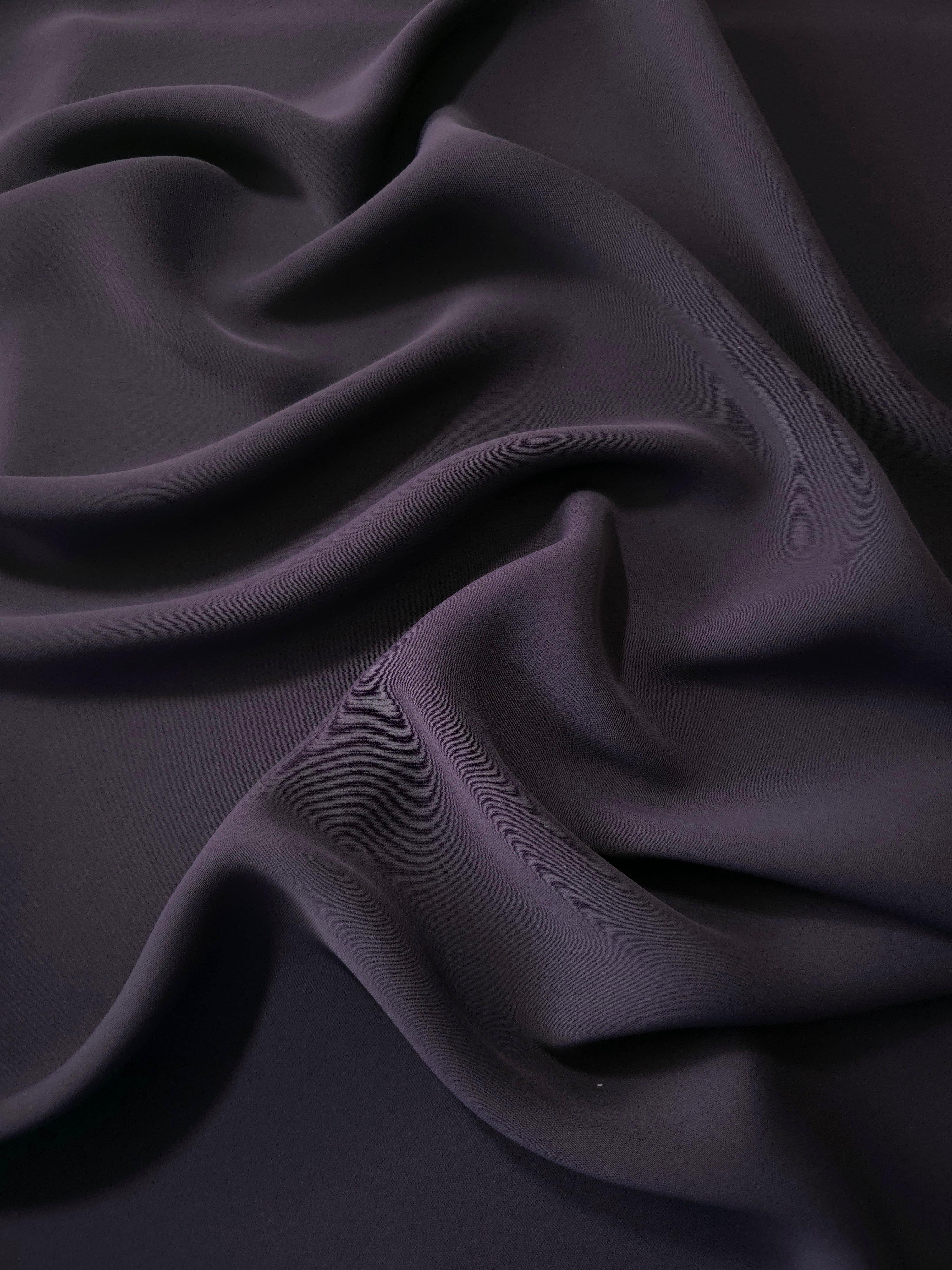 Deep Eggplant Purple Korean polyester dress fabric shown in draped folds for occasionwear, blouses and dresses