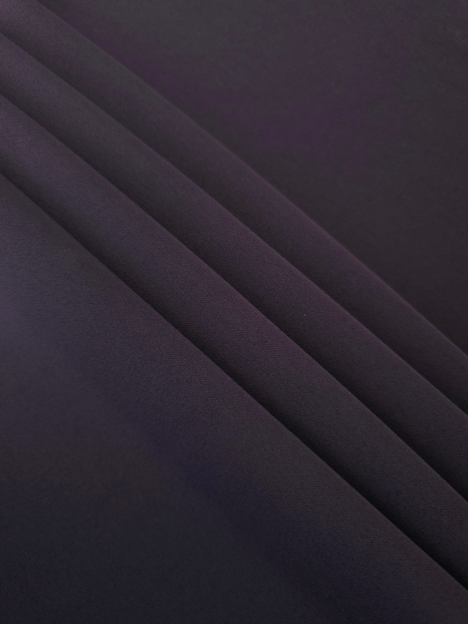 Deep Eggplant Purple mechanical polyester crepe layered to show soft structure for tailored garments and separates