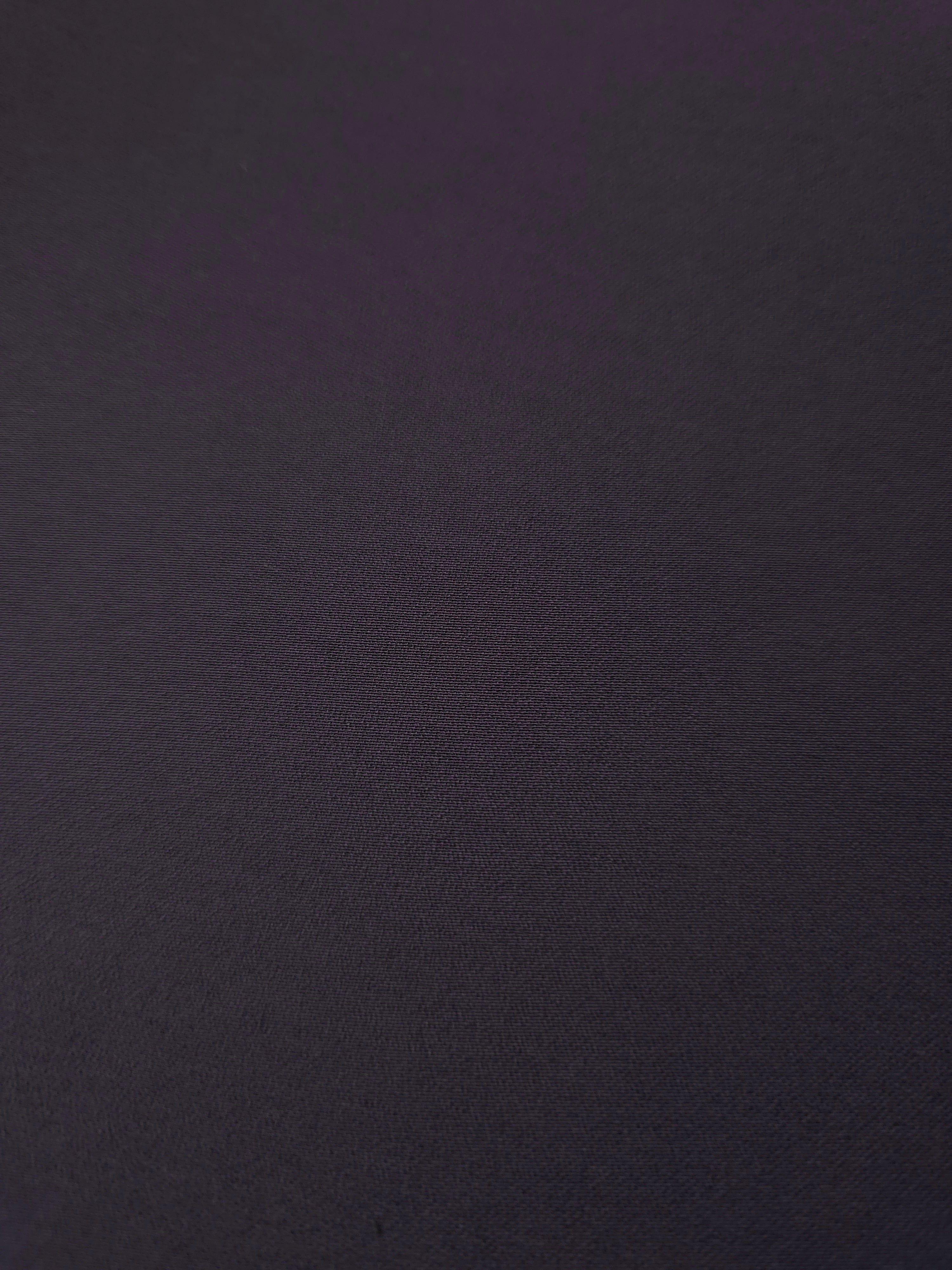 Close woven detail of Deep Eggplant Purple 100% polyester Korean crepe showing its smooth texture and soft finish