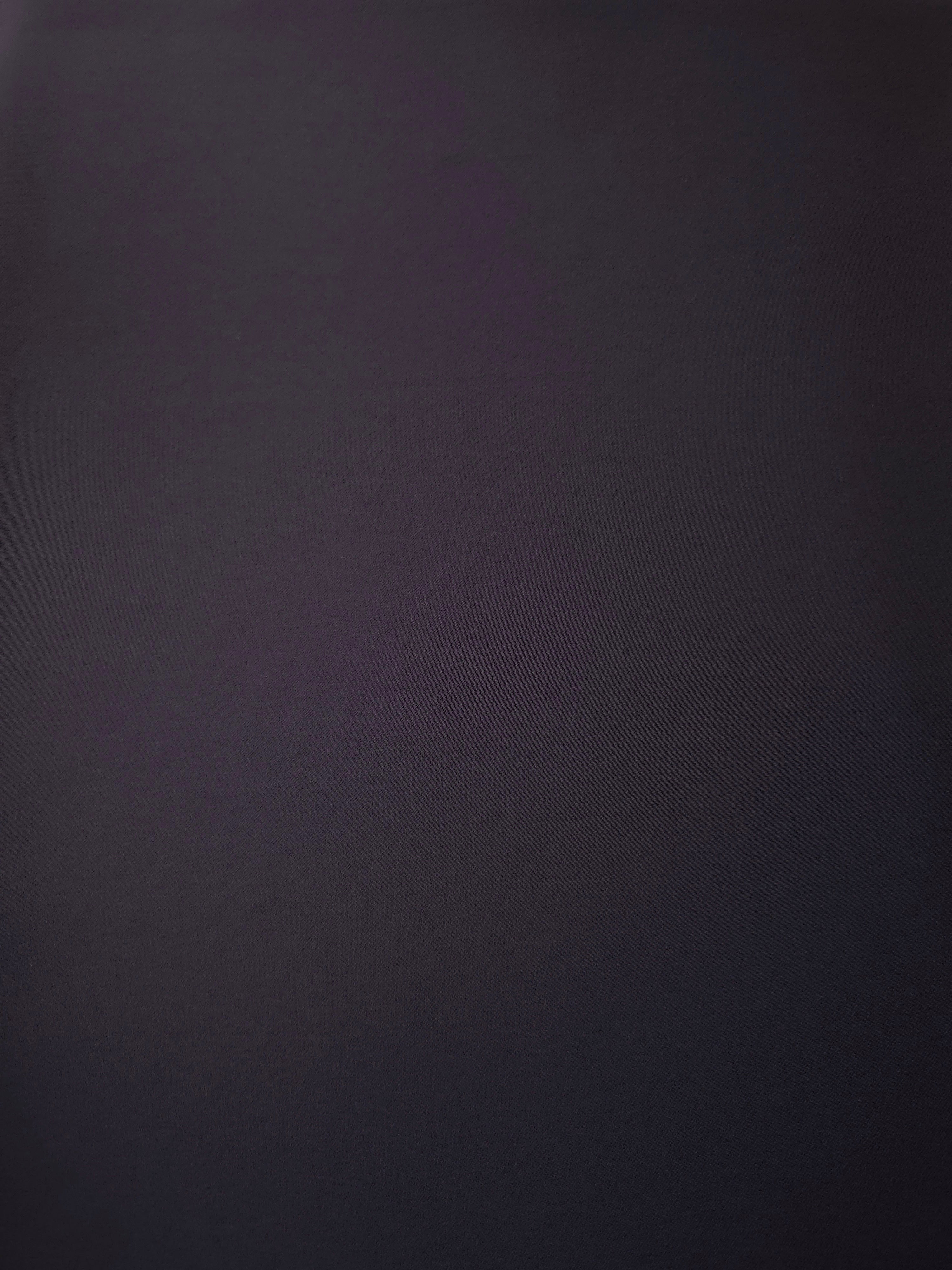 Surface view of Deep Eggplant Purple 205 GSM polyester crepe, opaque Korean dress fabric with a smooth woven finish