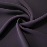 Flowing swirl of Deep Eggplant Purple Korean polyester crepe showing soft drape for blouses, dresses and abayas