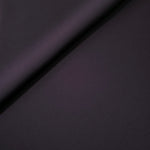 Loose fold of Deep Eggplant Purple polyester crepe showing smooth fluid drape for dresses, skirts and soft tailoring