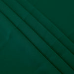 Layered Deep Emerald Green Korean polyester crepe showing gentle mechanical stretch and soft structure for dressmaking
