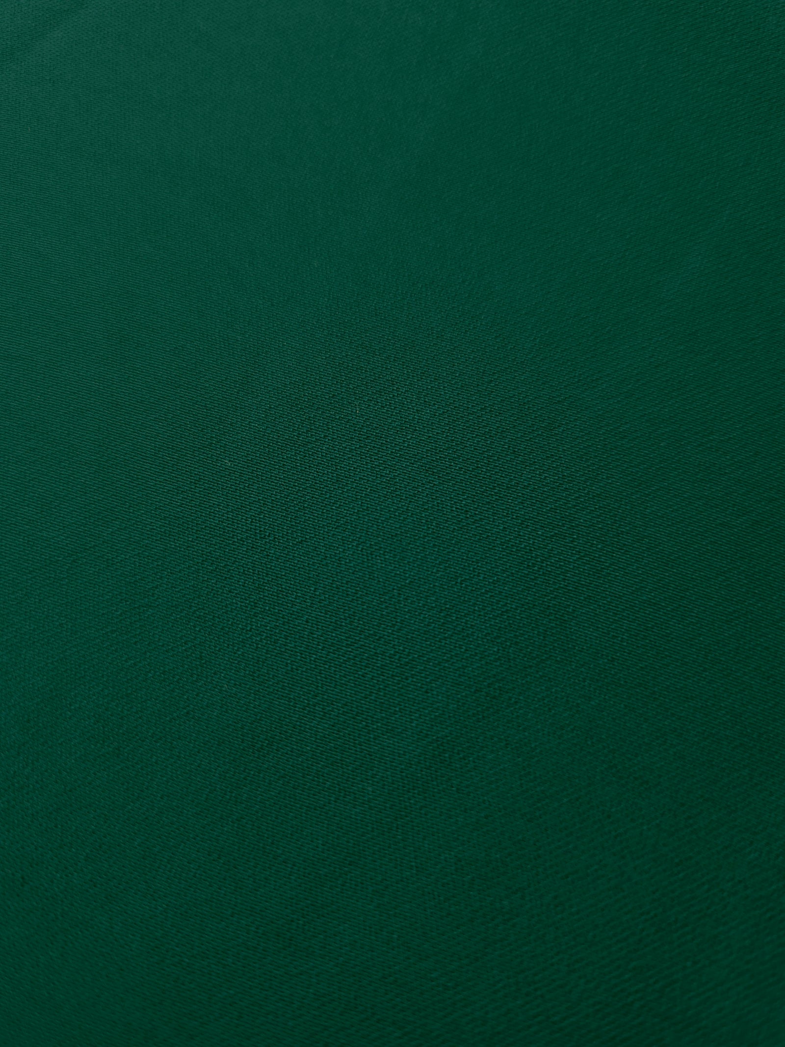 Deep Emerald Green mechanical polyester crepe in close-up, showing fine woven texture and a silky-soft surface