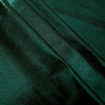 Deep Emerald Green metallic foiled spandex in layered folds, highlighting reflective texture and flexible structure for stage and eveningwear