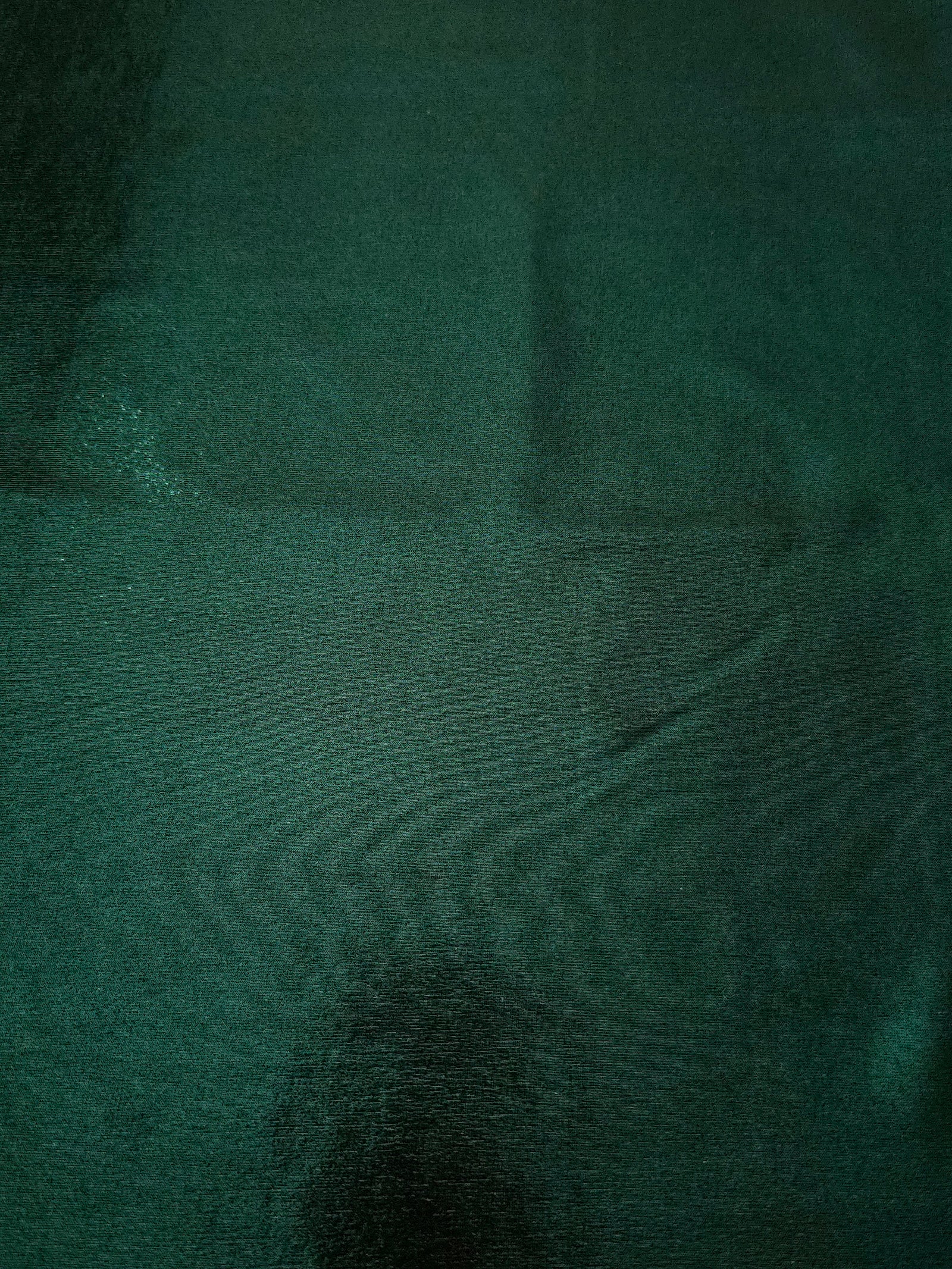 Flat view of Deep Emerald Green shimmer stretch fabric showing its metallic foil surface for costumes, partywear and fashion apparel