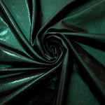 Swirled Deep Emerald Green metallic foiled spandex showing fluid movement and luminous sheen for dresses, dancewear and stage costumes