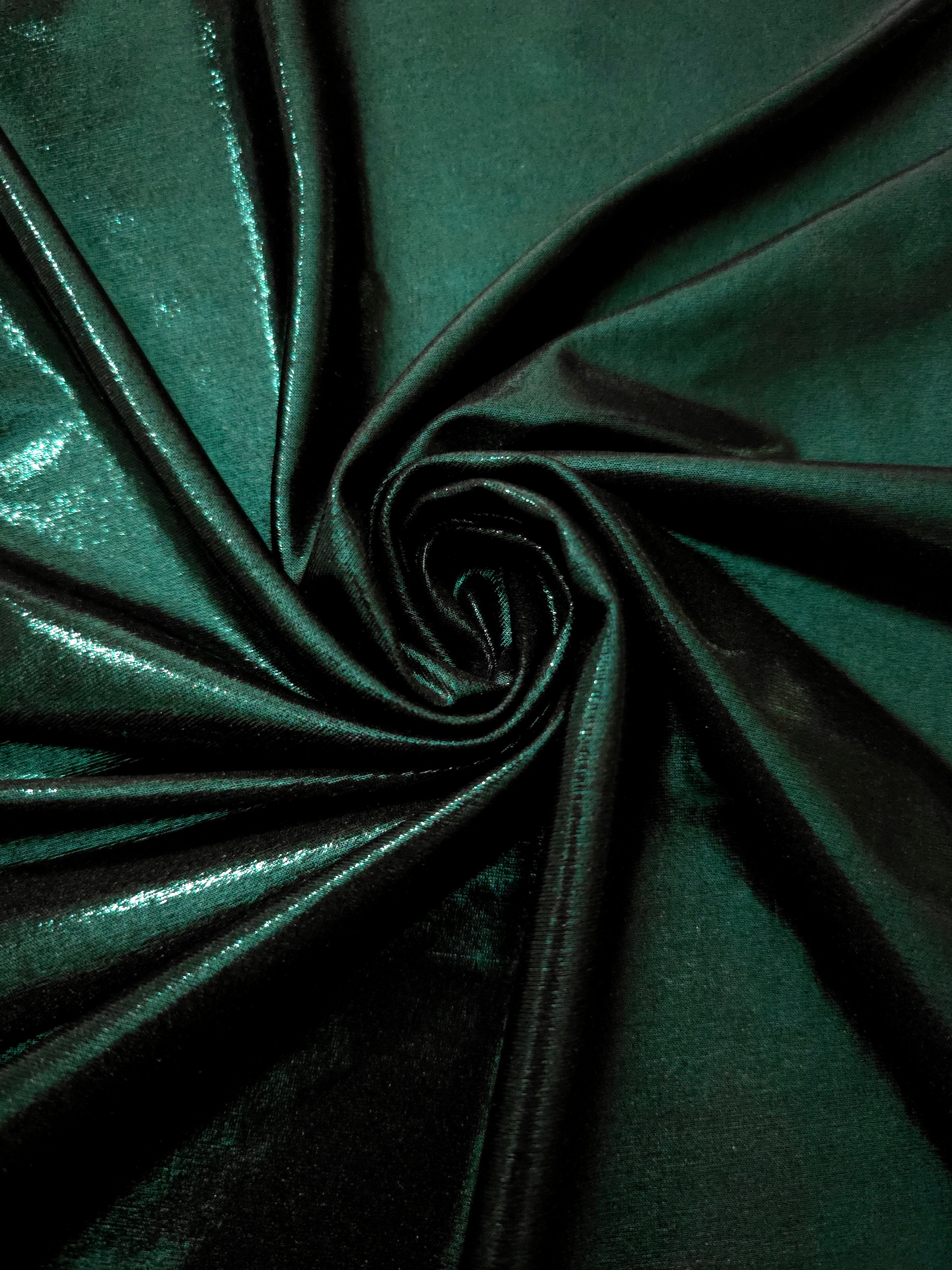 Swirled Deep Emerald Green metallic foiled spandex showing fluid movement and luminous sheen for dresses, dancewear and stage costumes