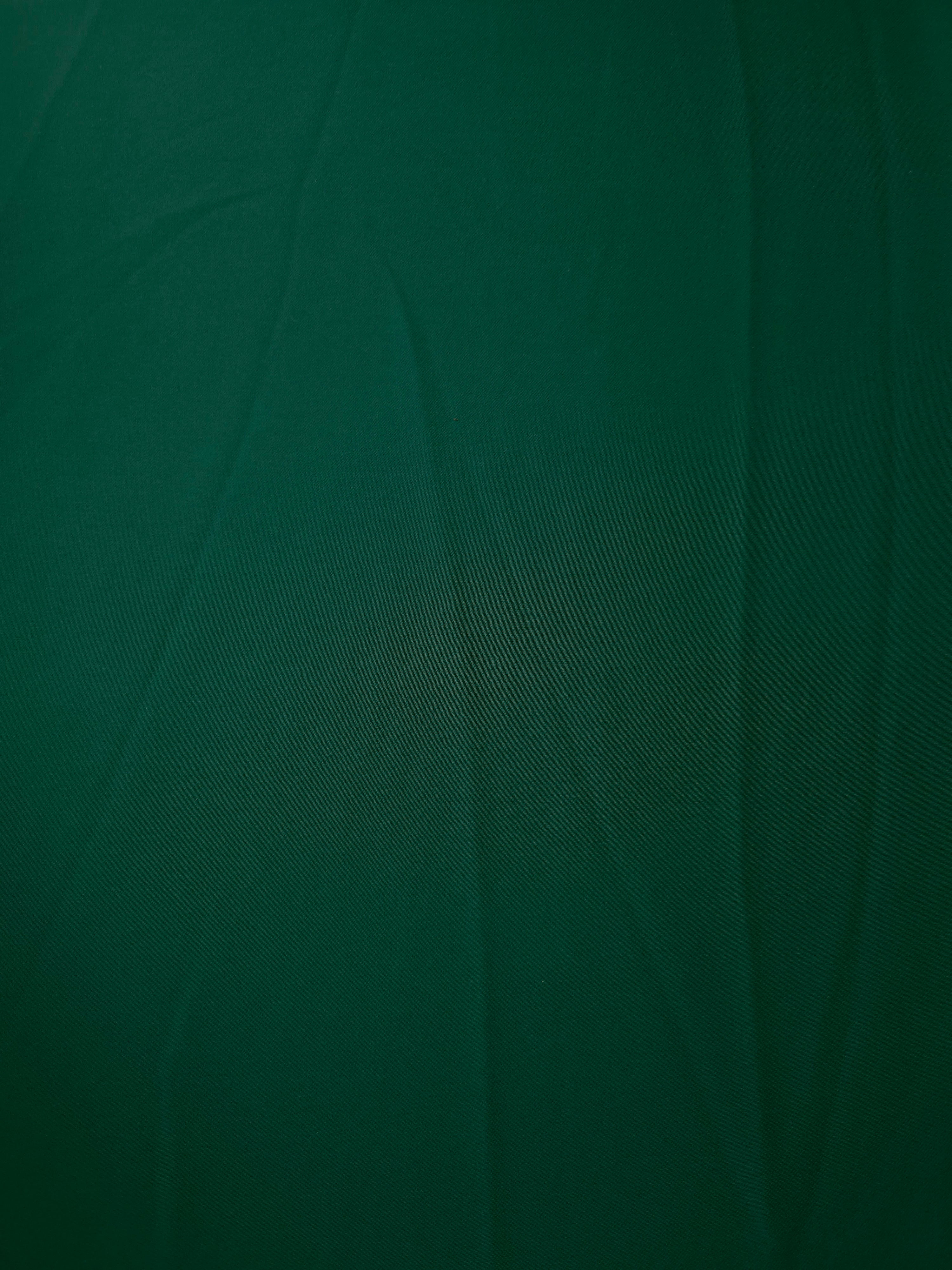 Deep Emerald Green opaque Korean polyester crepe shown flat, 205 GSM smooth woven fabric for dressmaking