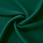 Deep Emerald Green silky-soft polyester crepe styled in a swirl to show fluid dressmaking drape and movement