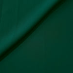 Deep Emerald Green opaque Korean polyester crepe in a soft fold, showing flowing drape for garment making