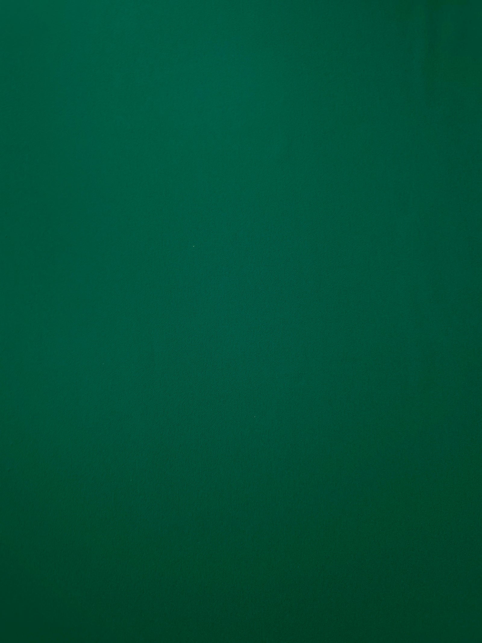 Deep Jade Green opaque Korean polyester crepe shown flat, 205 GSM smooth woven fabric for dressmaking