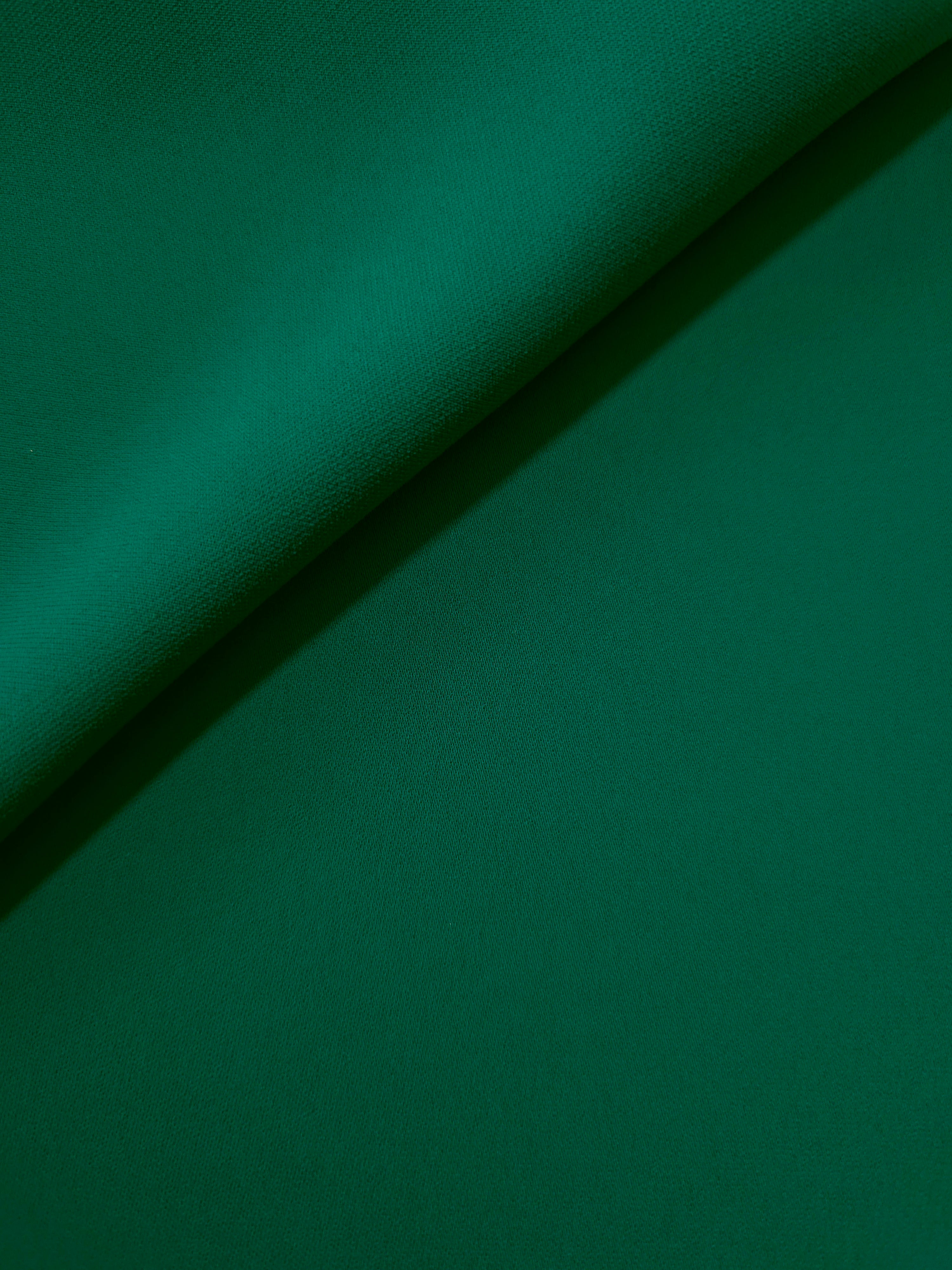Deep Jade Green opaque Korean polyester crepe in a soft fold, showing flowing drape for garment making