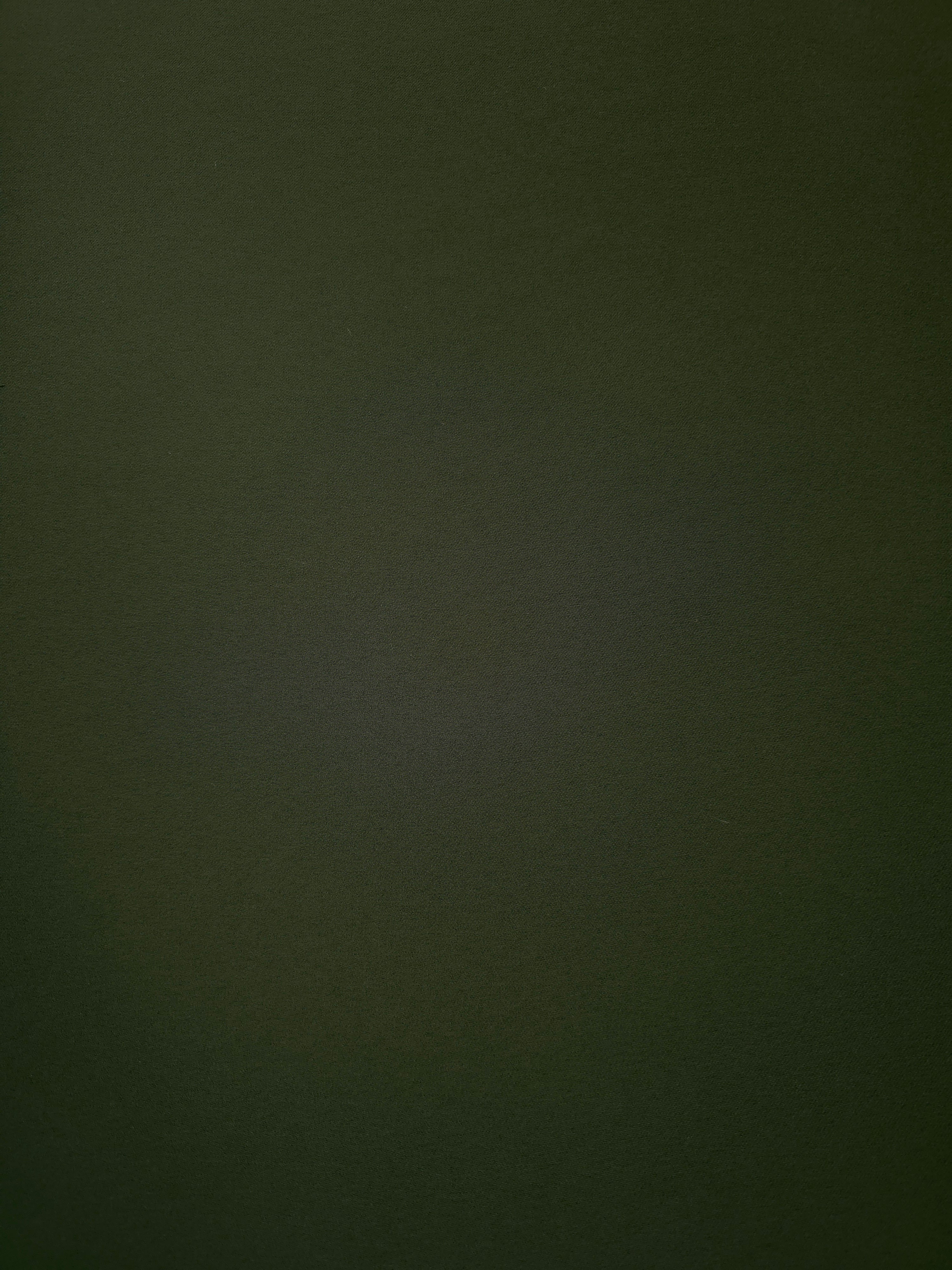 Surface view of Deep Olive Green 205 GSM polyester crepe, opaque Korean dress fabric with a smooth woven finish