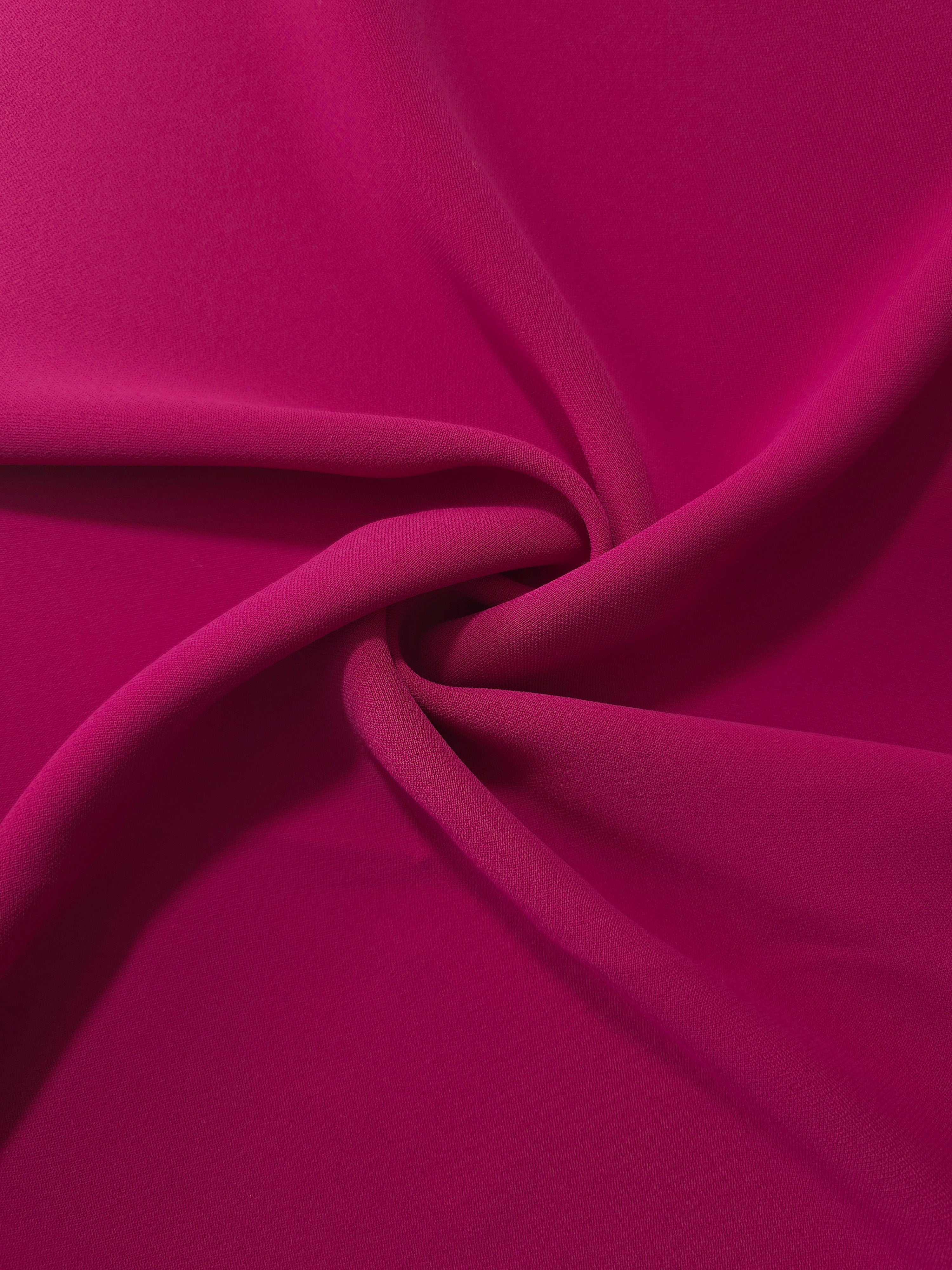Draped Deep Raspberry Pink Korean polyester crepe showing opaque fluid folds for evening dresses and occasionwear