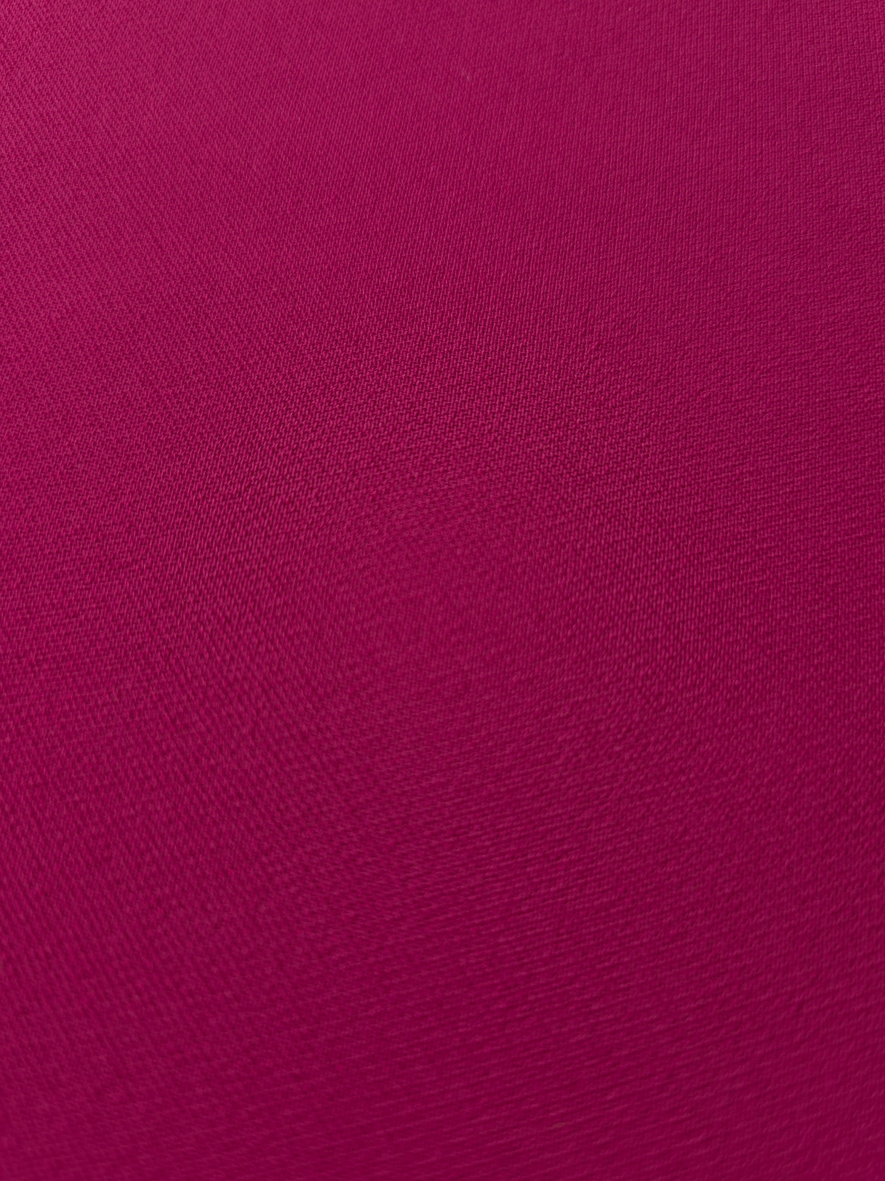 Layered Deep Raspberry Pink mechanical polyester crepe showing soft structure and slight mechanical stretch for tailoring