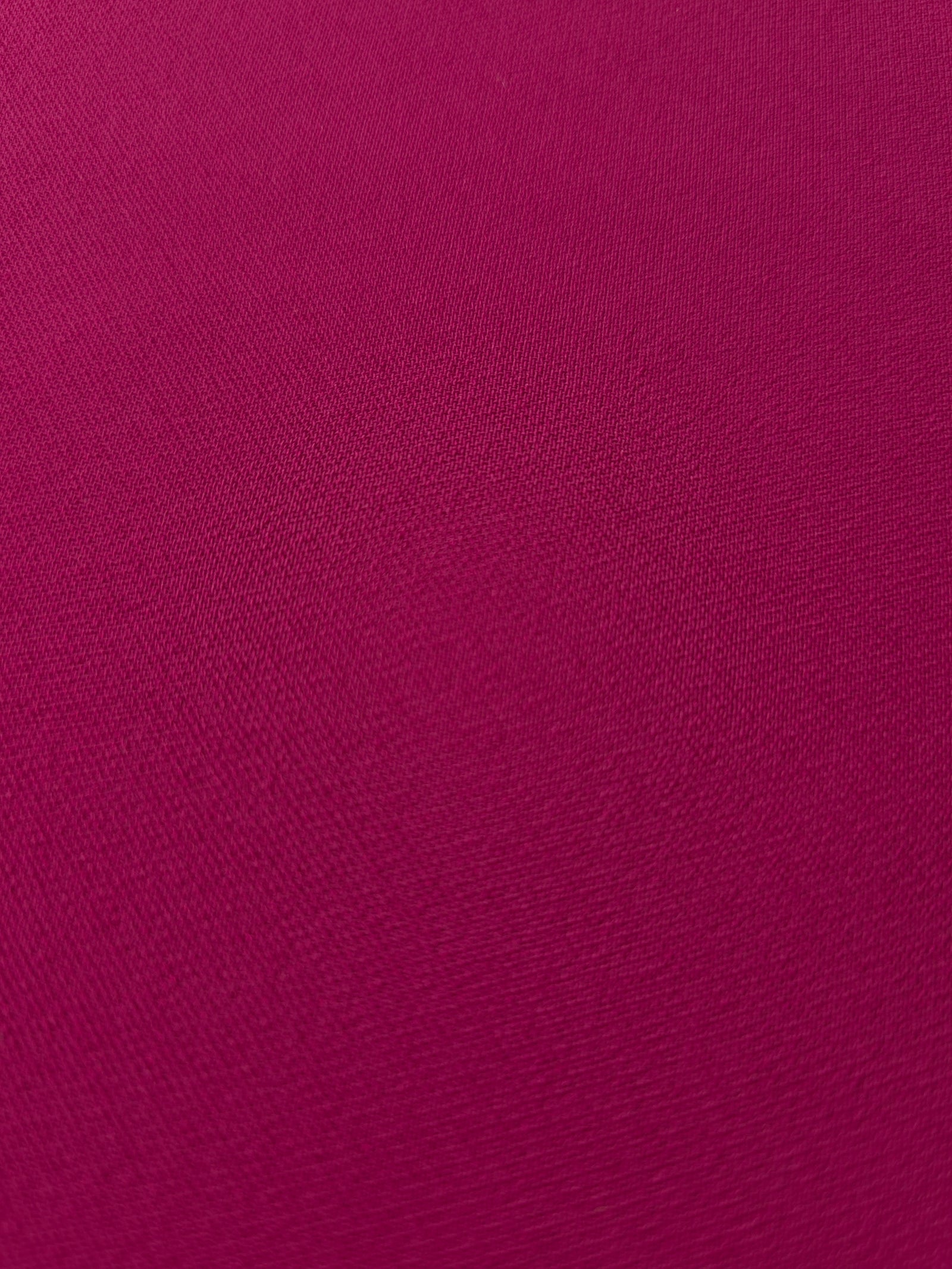 Layered Deep Raspberry Pink mechanical polyester crepe showing soft structure and slight mechanical stretch for tailoring