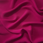Deep Raspberry Pink Korean polyester crepe in a soft fold, showing fluid drape for blouses and flowing dresses